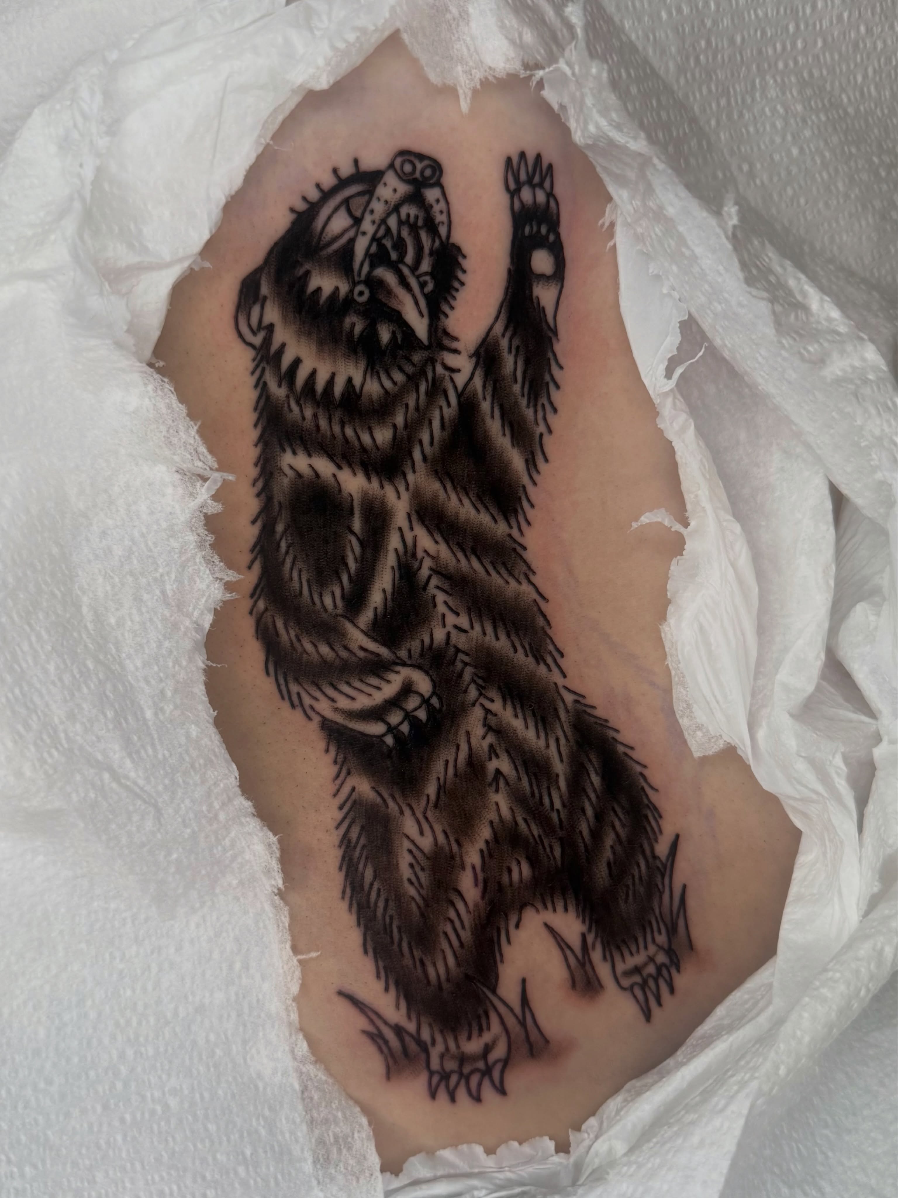 Bear black and grey tattoo on the ribs by Lexie Graff