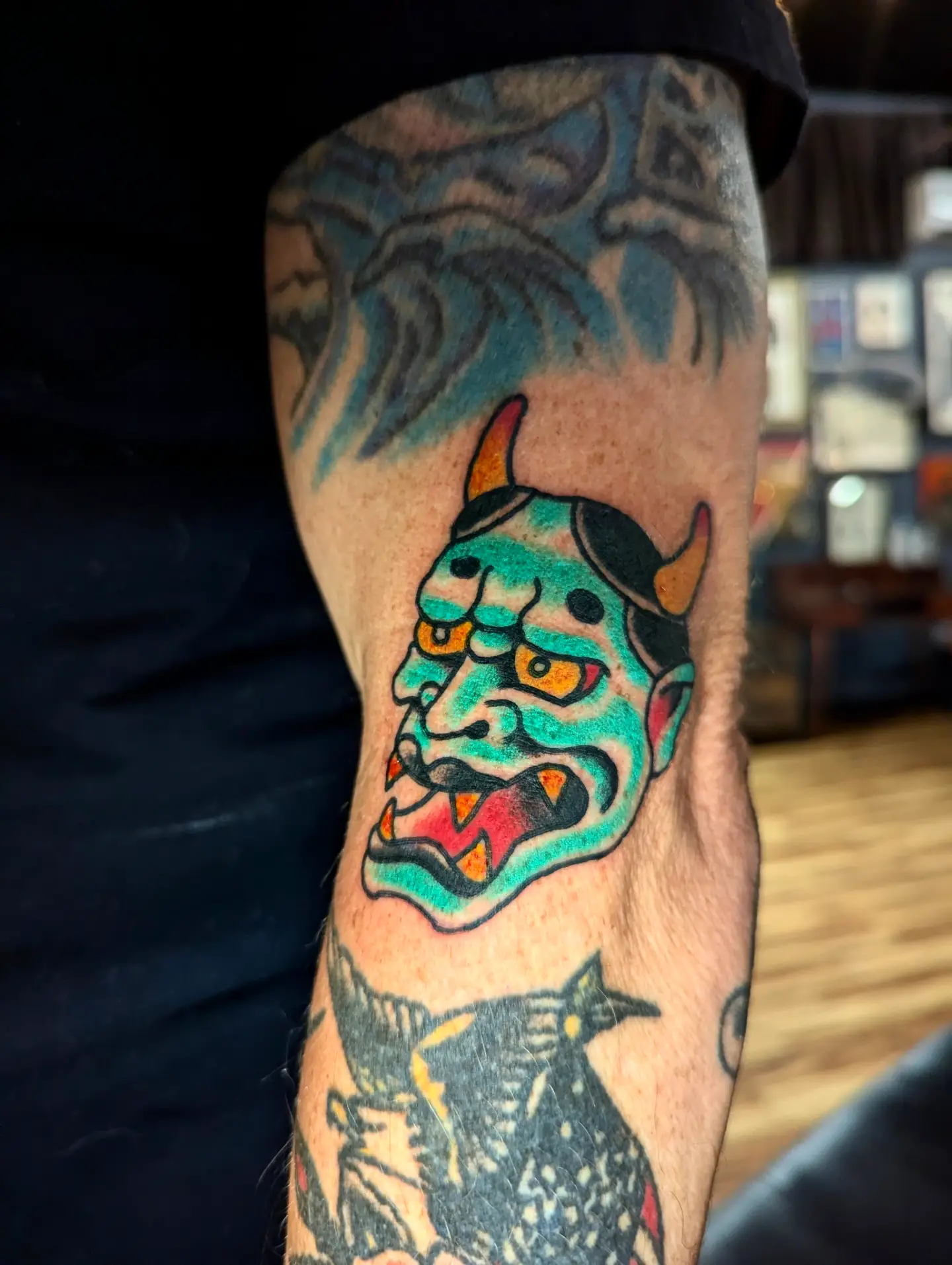 Demon mask American traditional tattoo on the forearm by Eric Ward