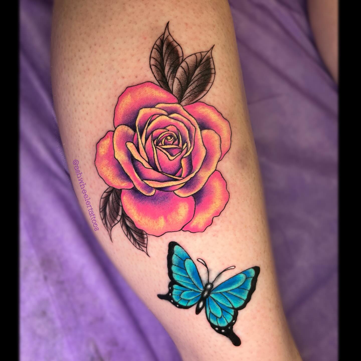 Rose and butterfly realism tattoo on the forearm by Ash Wheeler