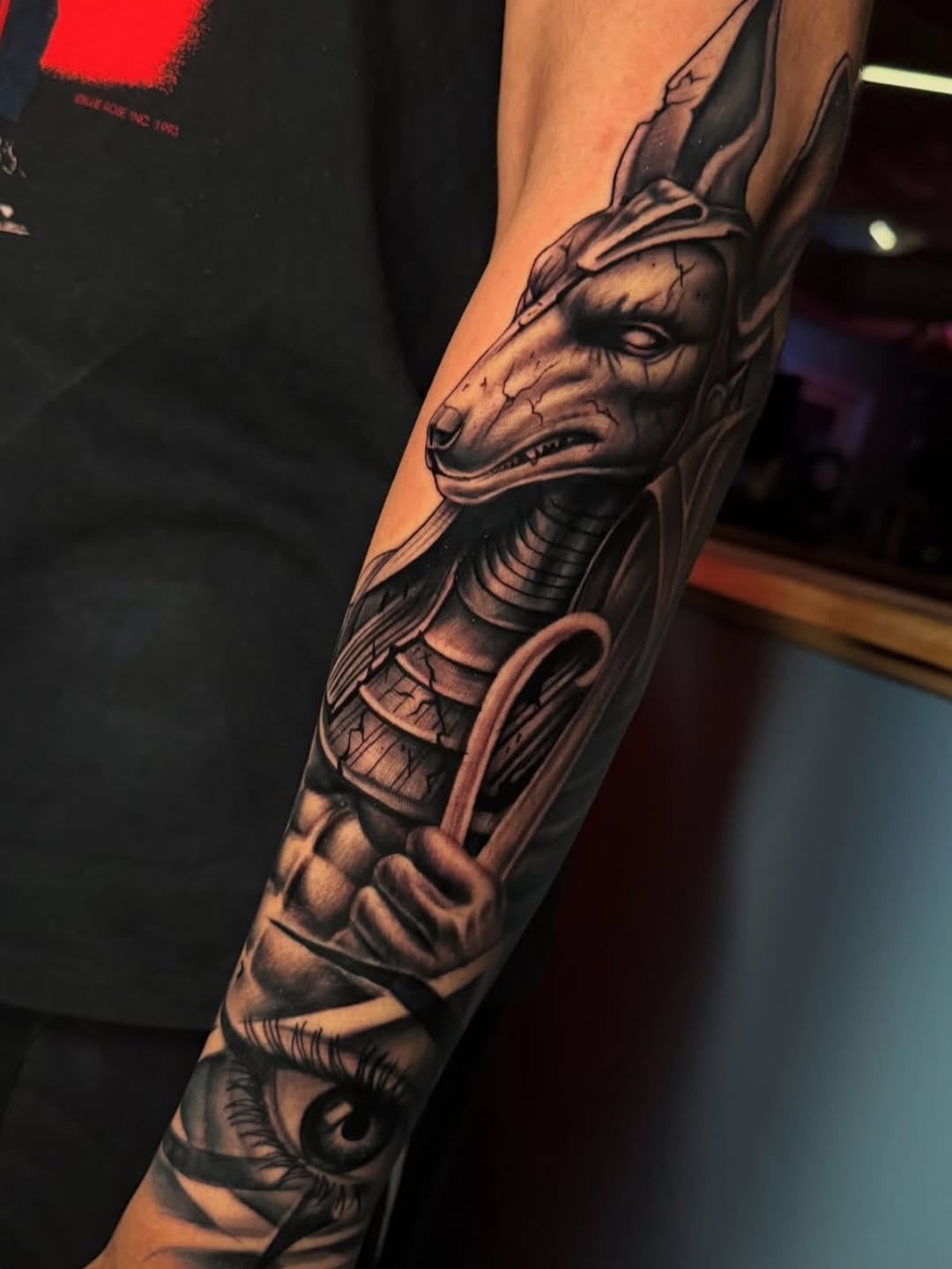 Anubis and eye realism tattoo on the forearm by Terrence jones