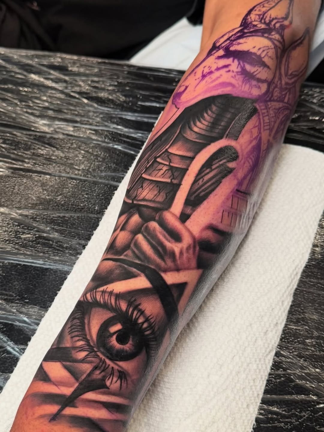 Egyptian god Anubis and eye realism tattoo on the forearm by Terrence jones