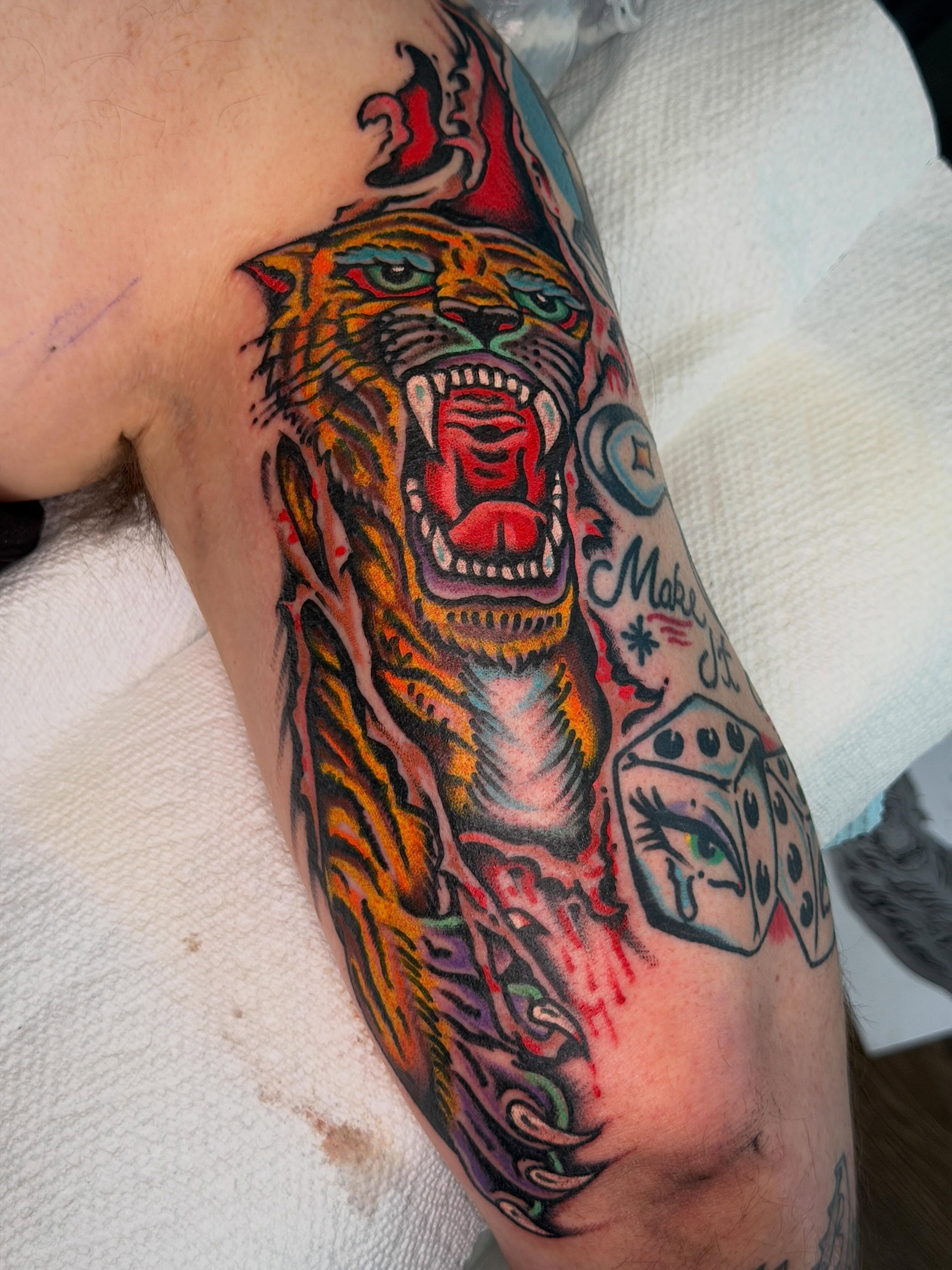 Roaring tiger American traditional tattoo on the forearm by Joshua Speight