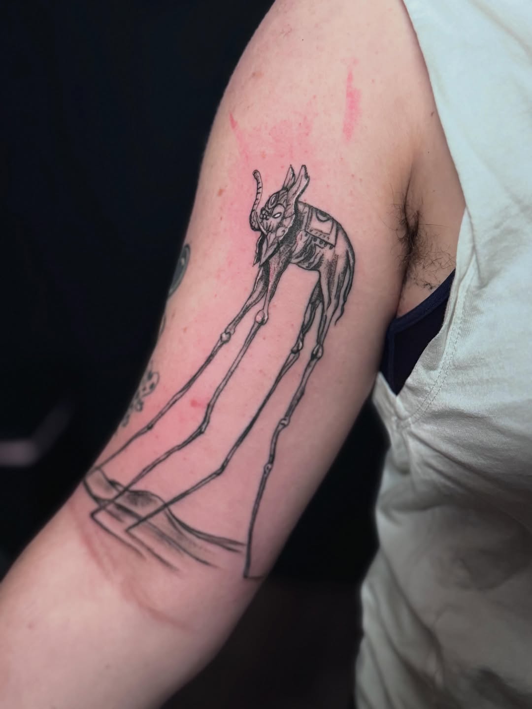 Surrealist elephant with long legs sketch tattoo on the forearm by Gisette Gomez