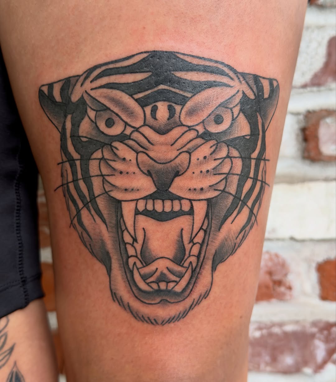 Roaring tiger head realism tattoo on the thigh by Charlotte (Luna), Seattle, Washington
