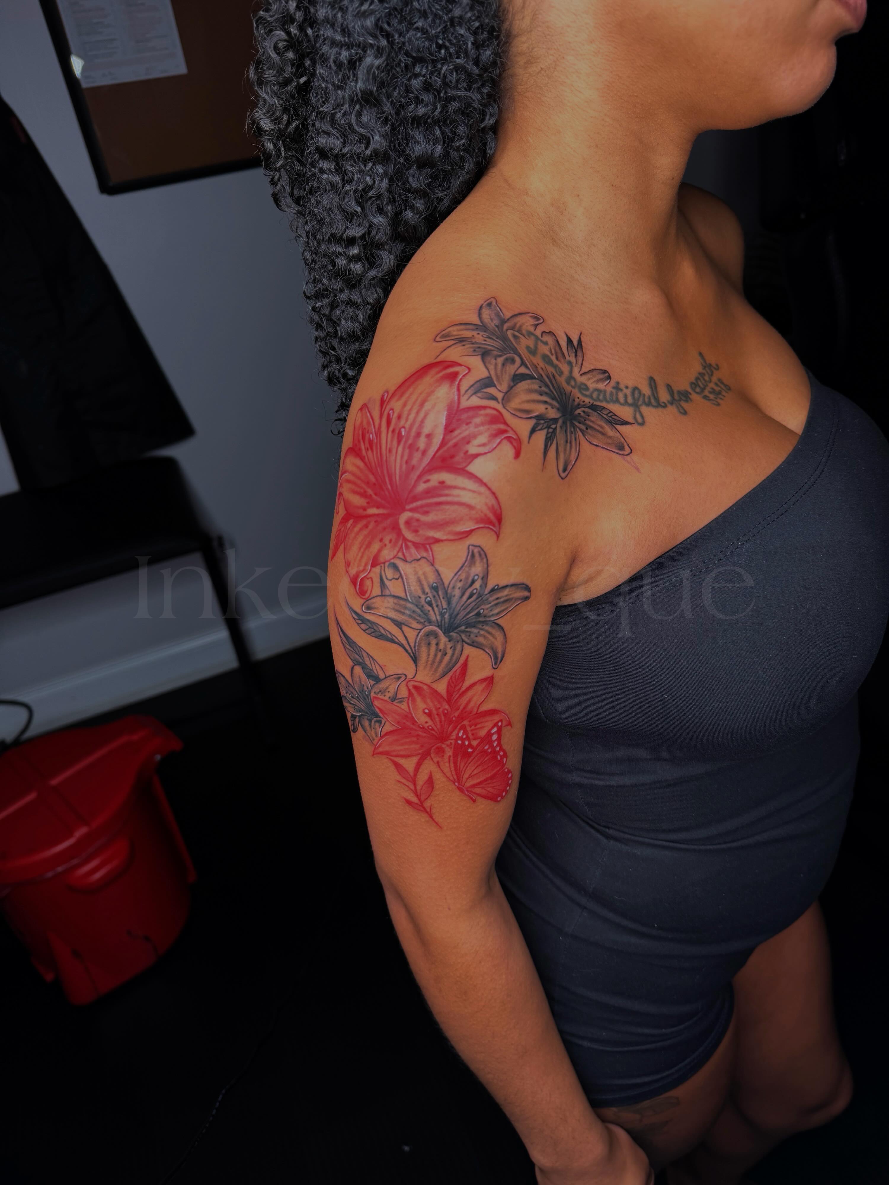 Lilies realism tattoo on the upper arm by Q⚜️