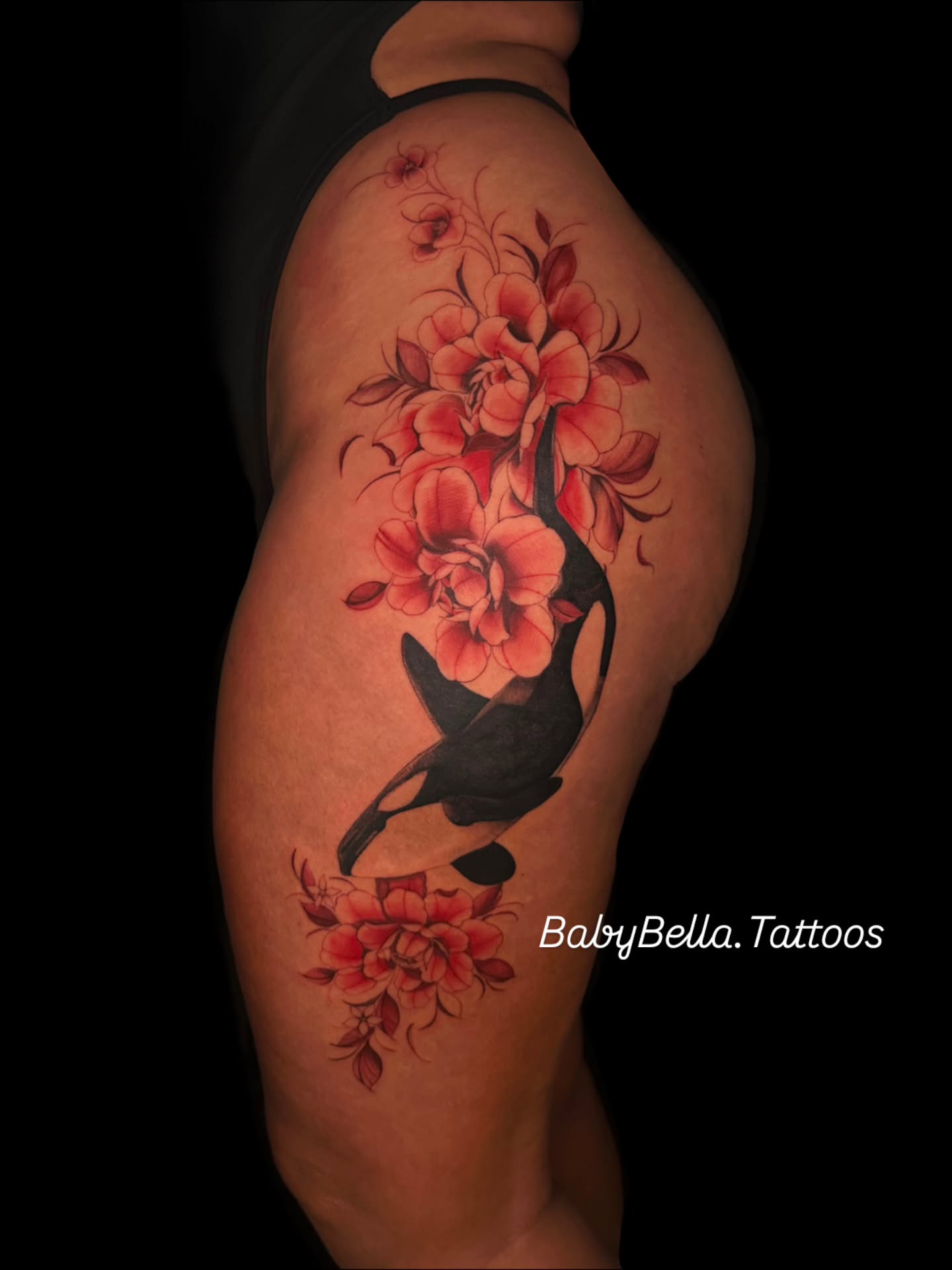 Koi fish and flowers realism tattoo on the thigh by Elizabeth Stepp