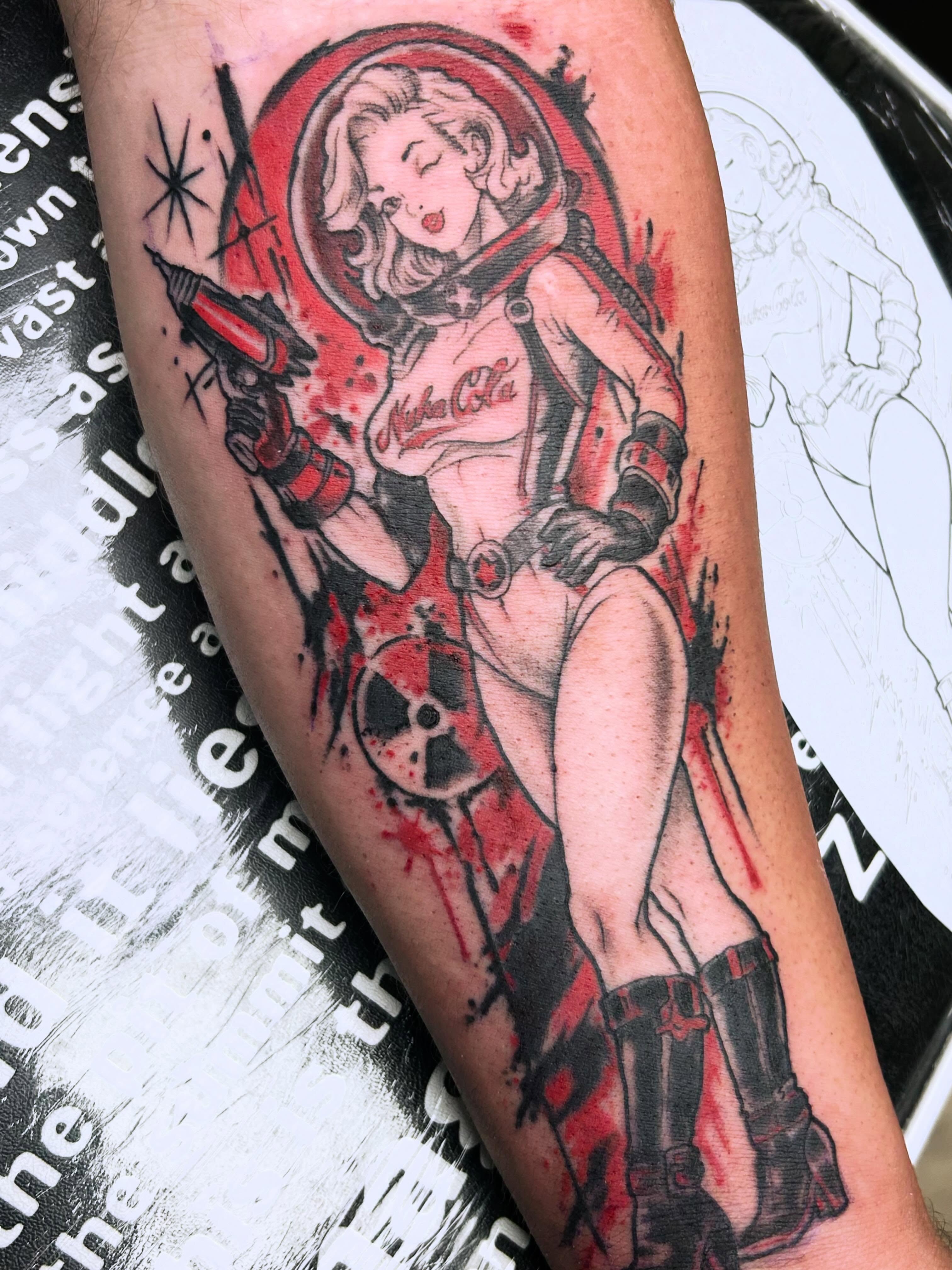 Cosmic pin-up girl illustrative tattoo on the forearm by Dan Schuster