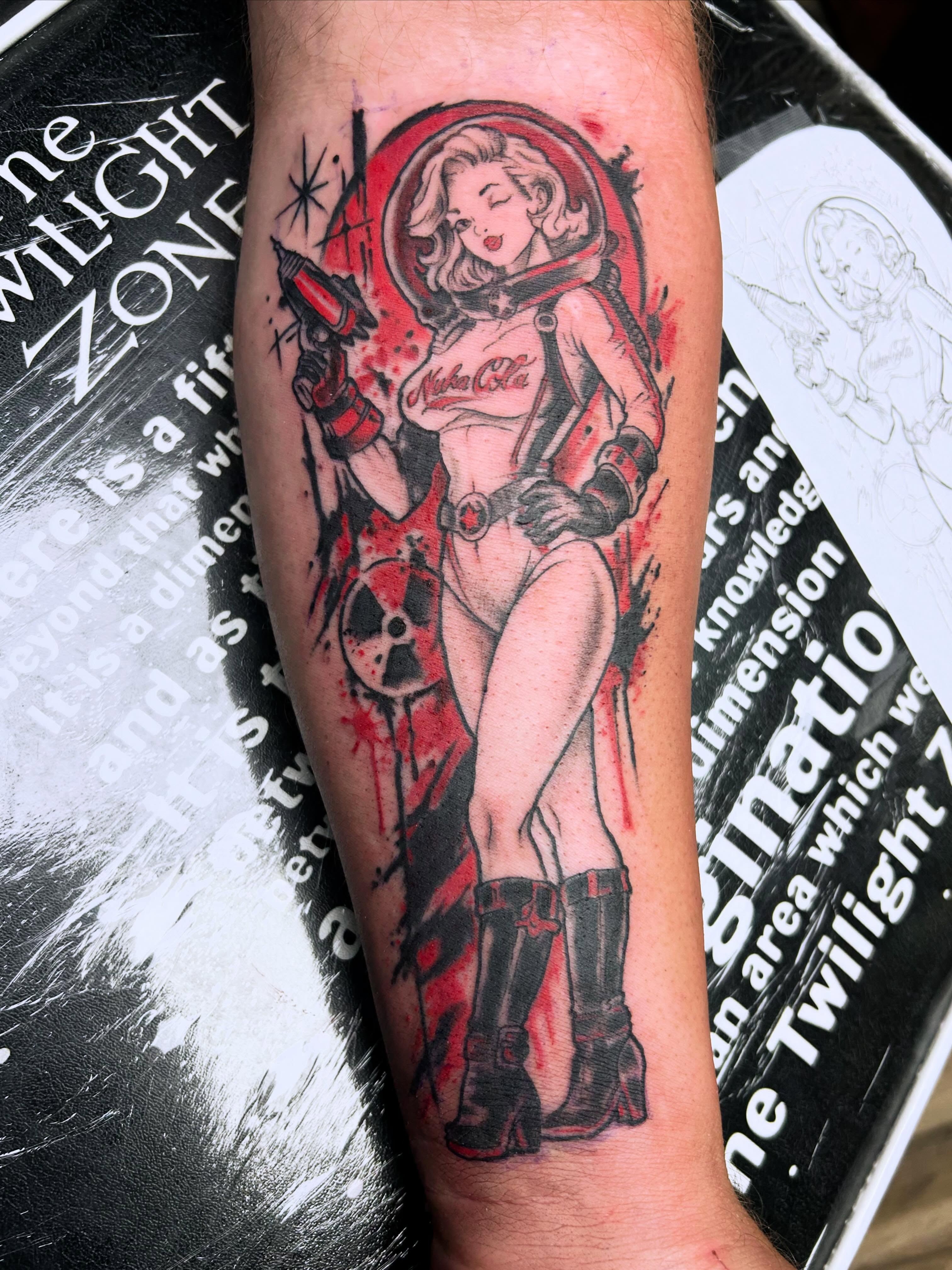 Cosmic pin-up girl American traditional tattoo on the forearm by Dan Schuster