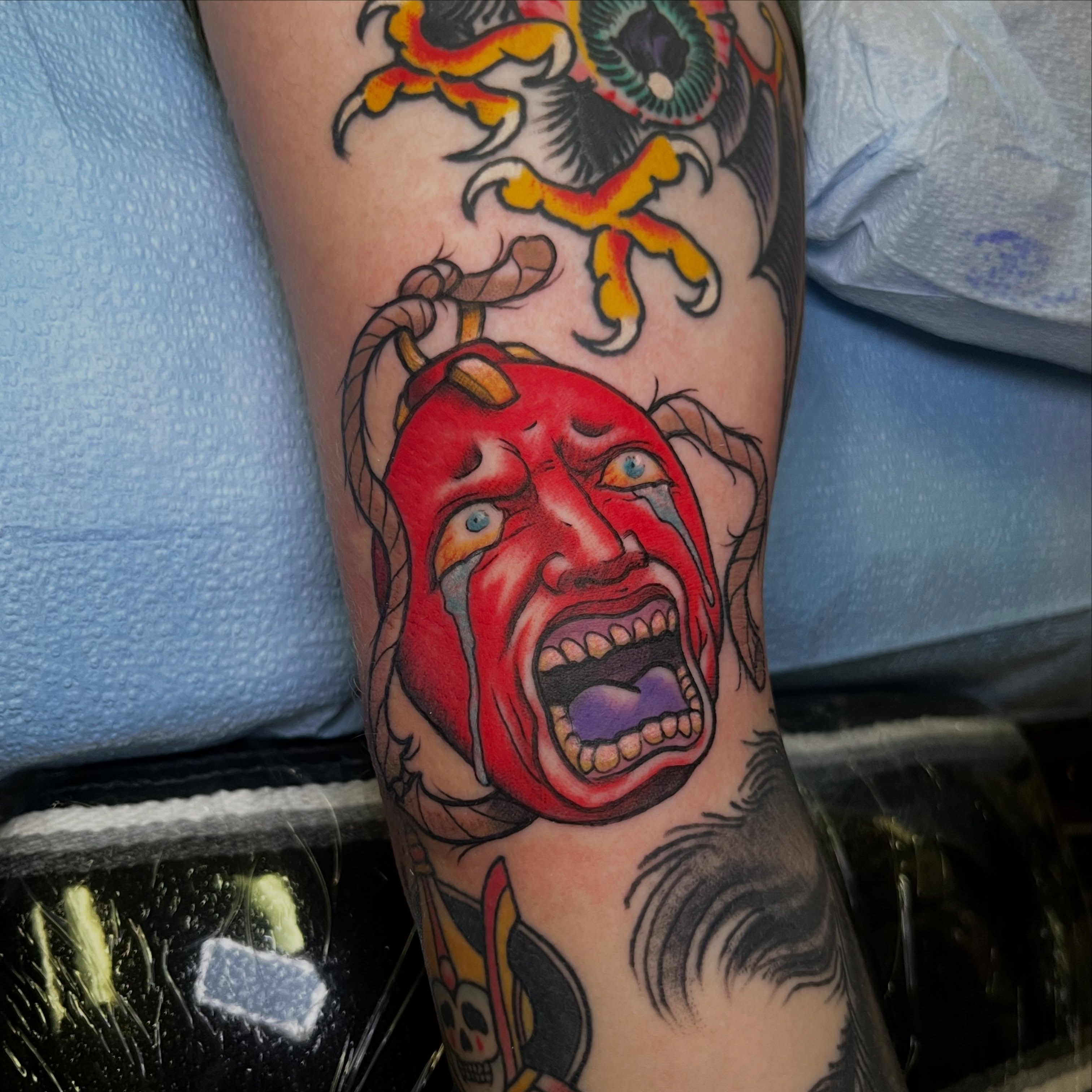 Screaming face American traditional tattoo on the forearm by Evan Perrine
