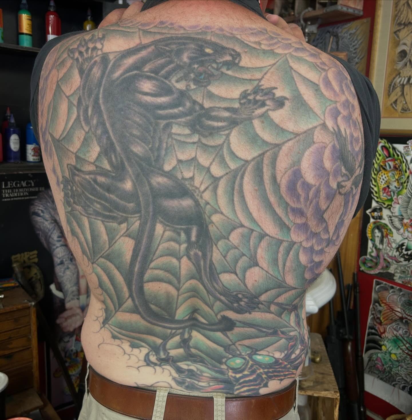 Panther and floral American traditional tattoo on the back by Jim Rosal