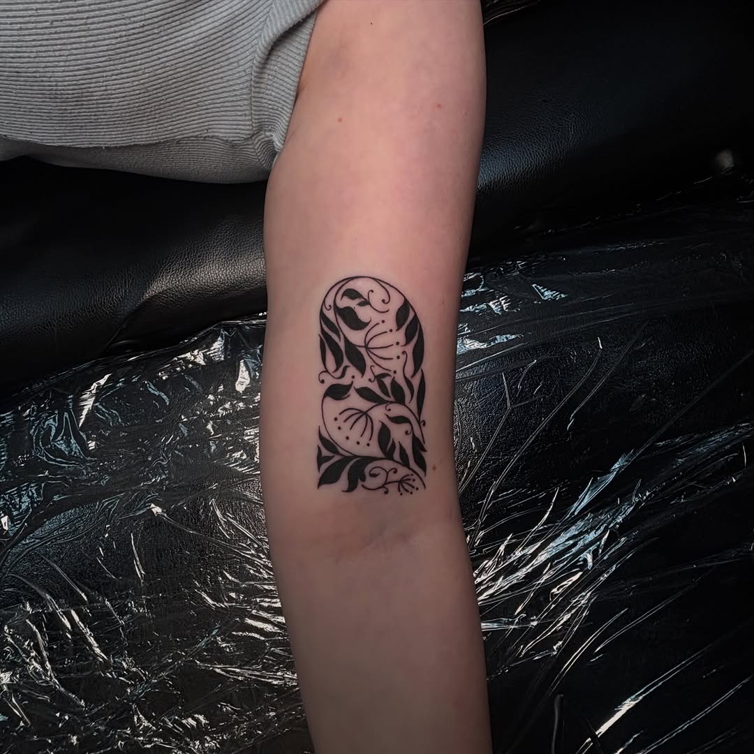 Floral archway ornamental tattoo on the forearm by Rachel