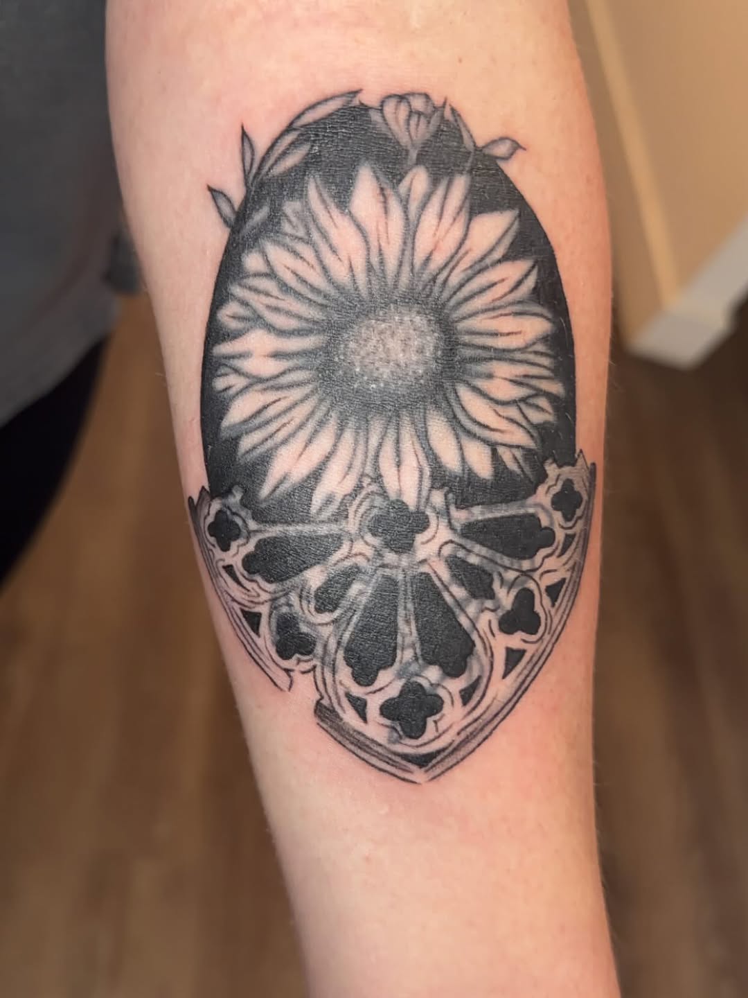 Sunflower and gothic window geometric tattoo on the forearm by Natalie
