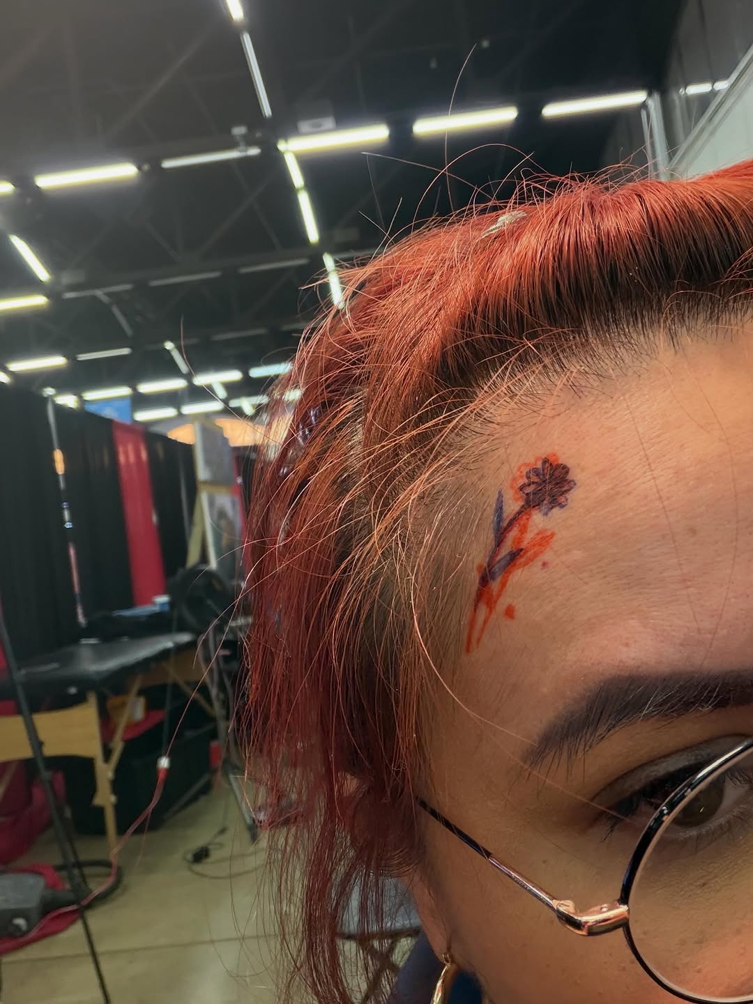 Flower with stem tattoo on the head by Natalie