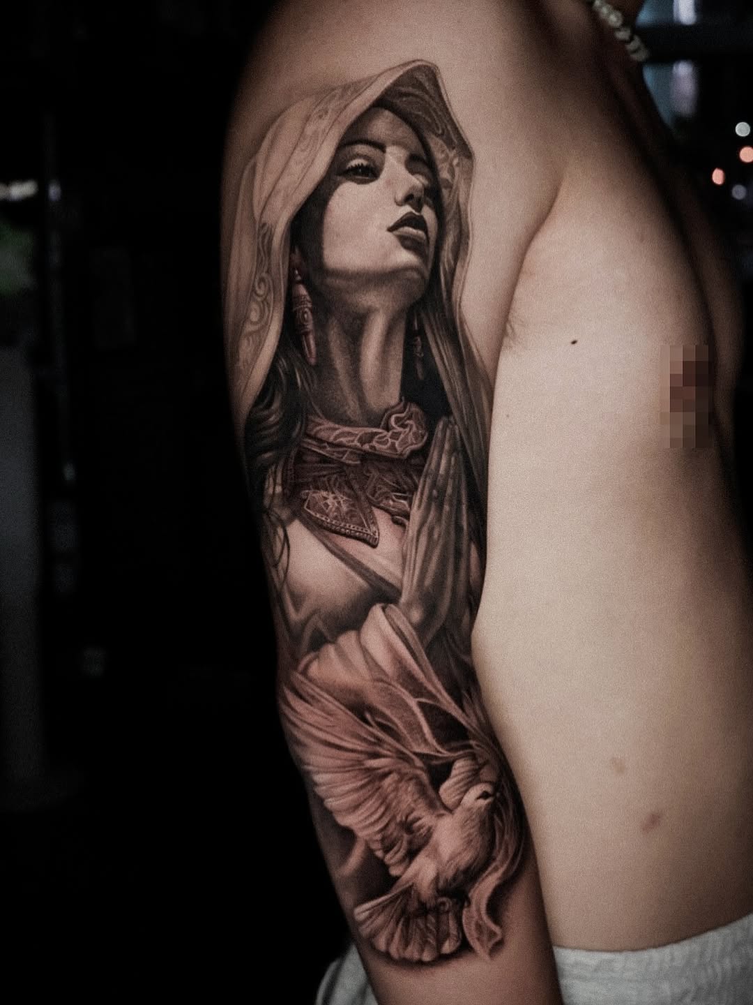 Woman with praying hands and dove Chicano tattoo on the forearm by D A N N y L I N