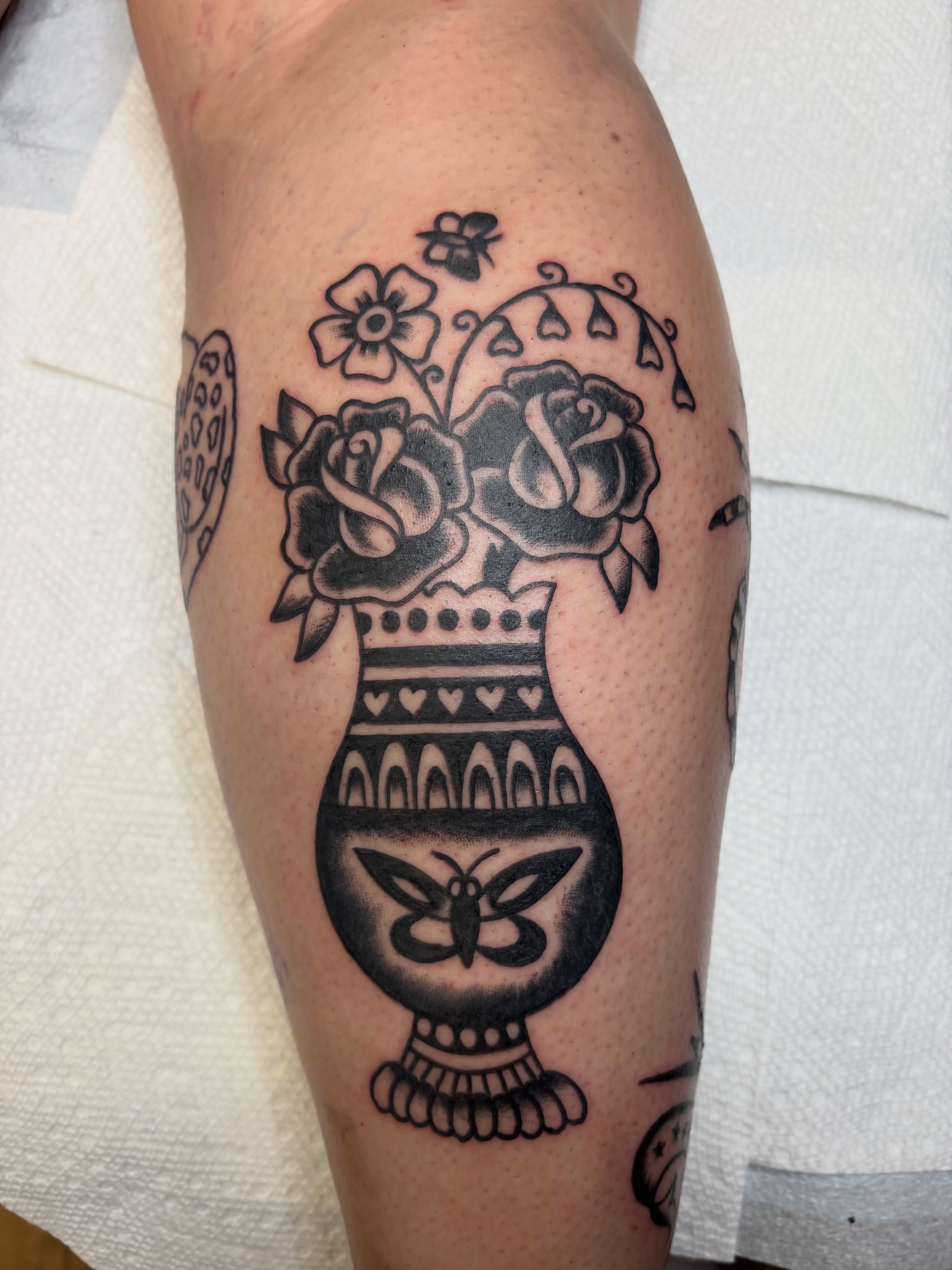 Vase with roses black and grey tattoo on the forearm by Cooper Reichwein