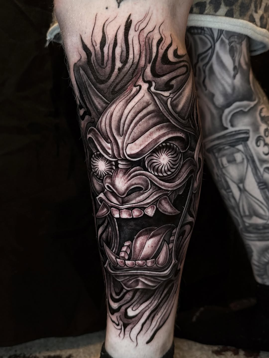 Oni mask with flames Japanese tattoo on the forearm by Elidia Veliz