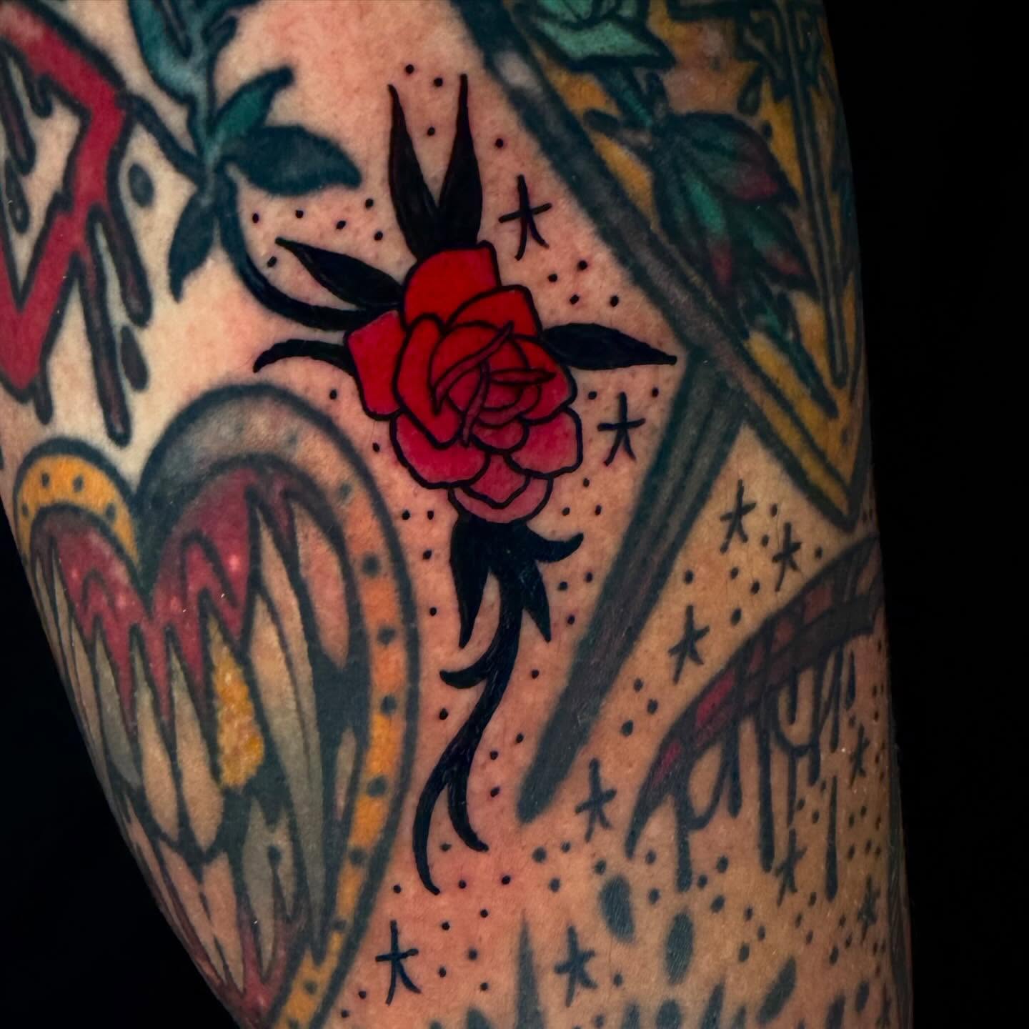 Red rose American traditional tattoo on the forearm by Trenton Helms