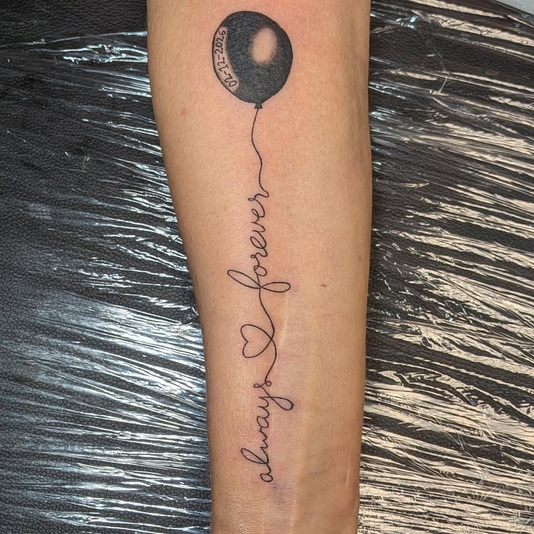 Balloon with script lettering lettering tattoo on the forearm by Kam