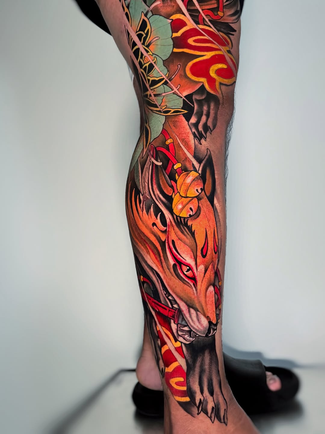 Fox mask with clouds and bells Japanese tattoo on the calf by Aitor Arie, Roseville, California