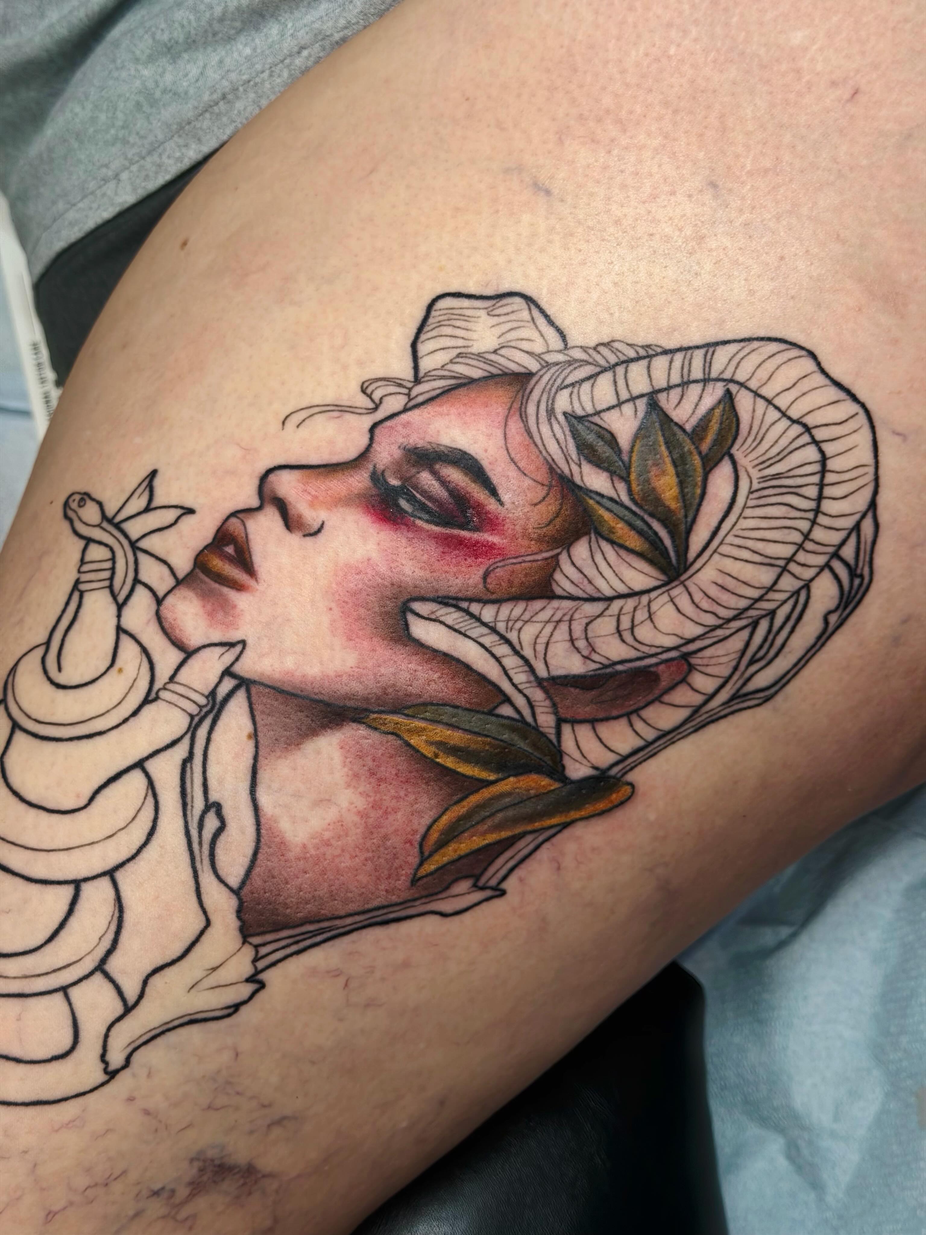 Woman with snake American traditional tattoo on the thigh by Emily