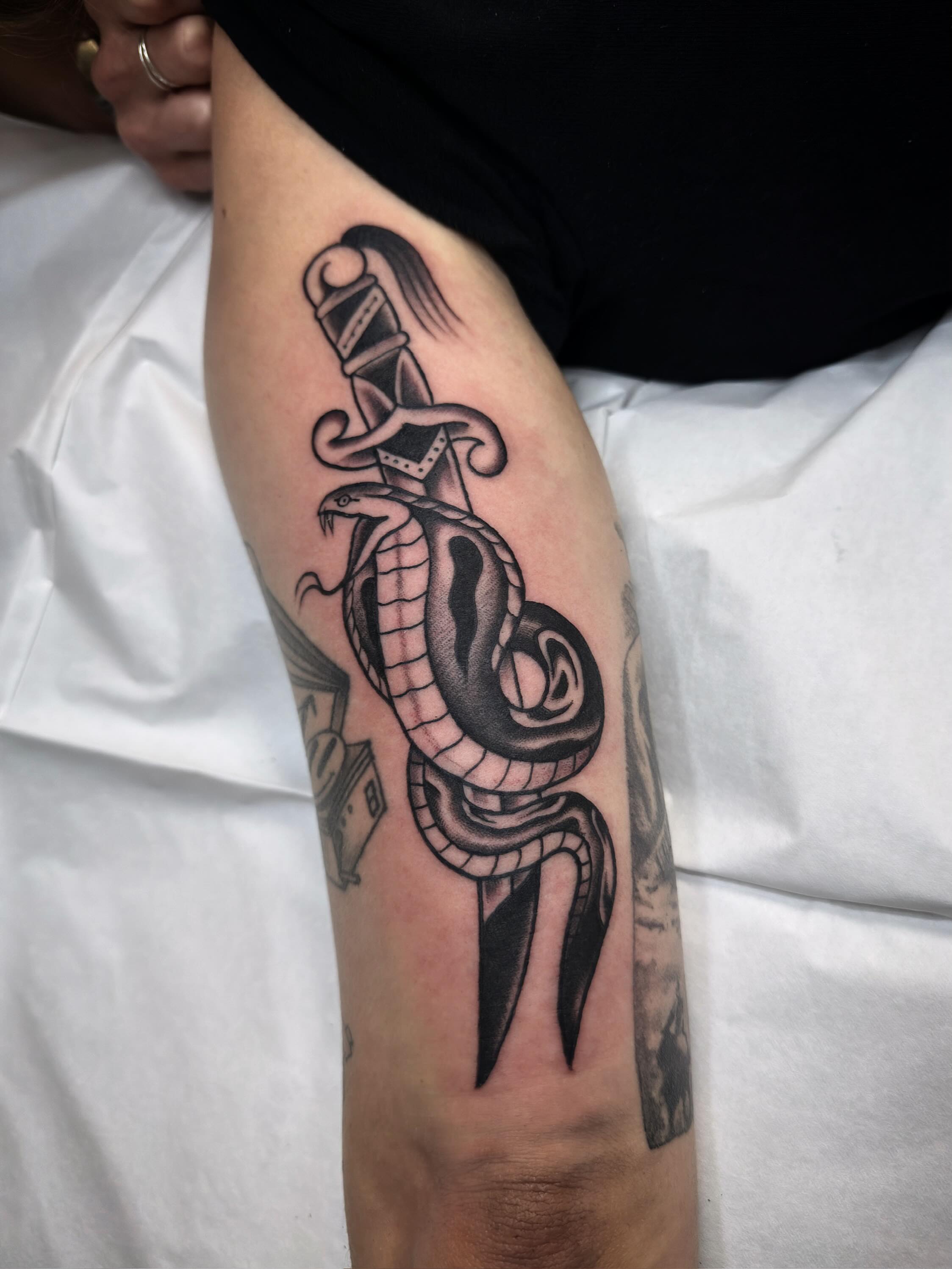 Snake and dagger black and grey tattoo on the forearm by Trav, Bayville, New Jersey