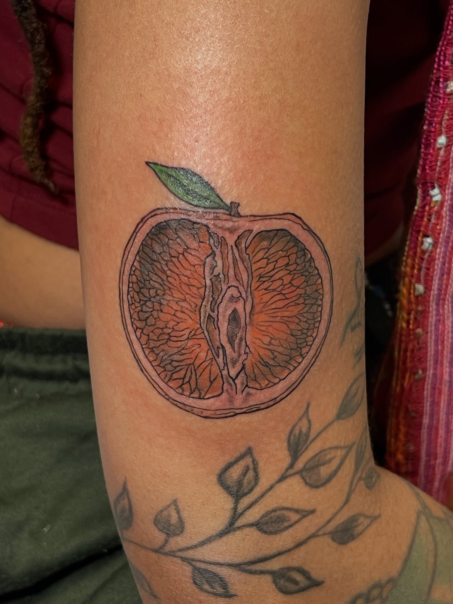 Orange slice realism tattoo on the forearm by Ashley Antolin