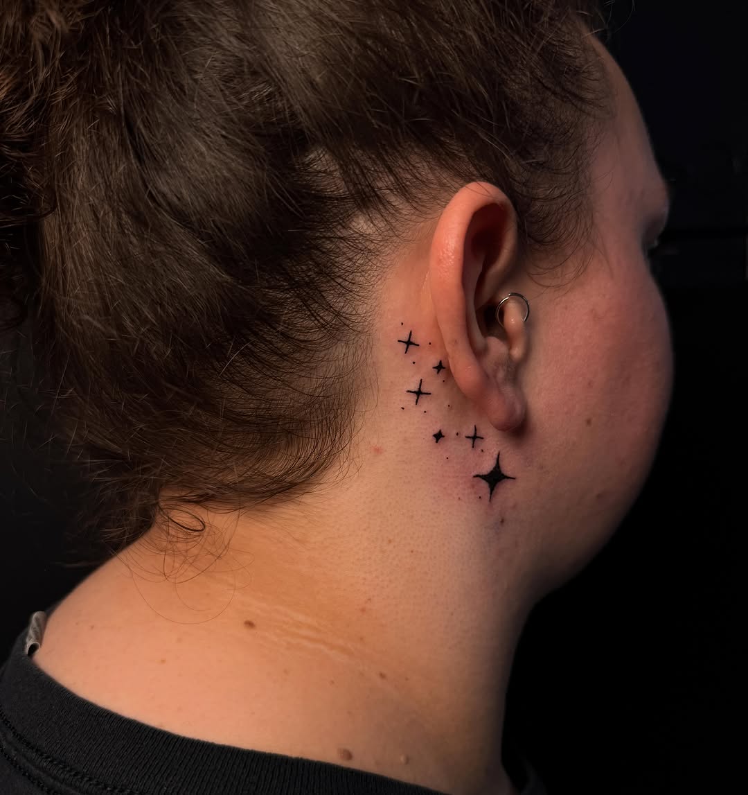 Sparkling stars sketch tattoo on the neck by Scout Meyer