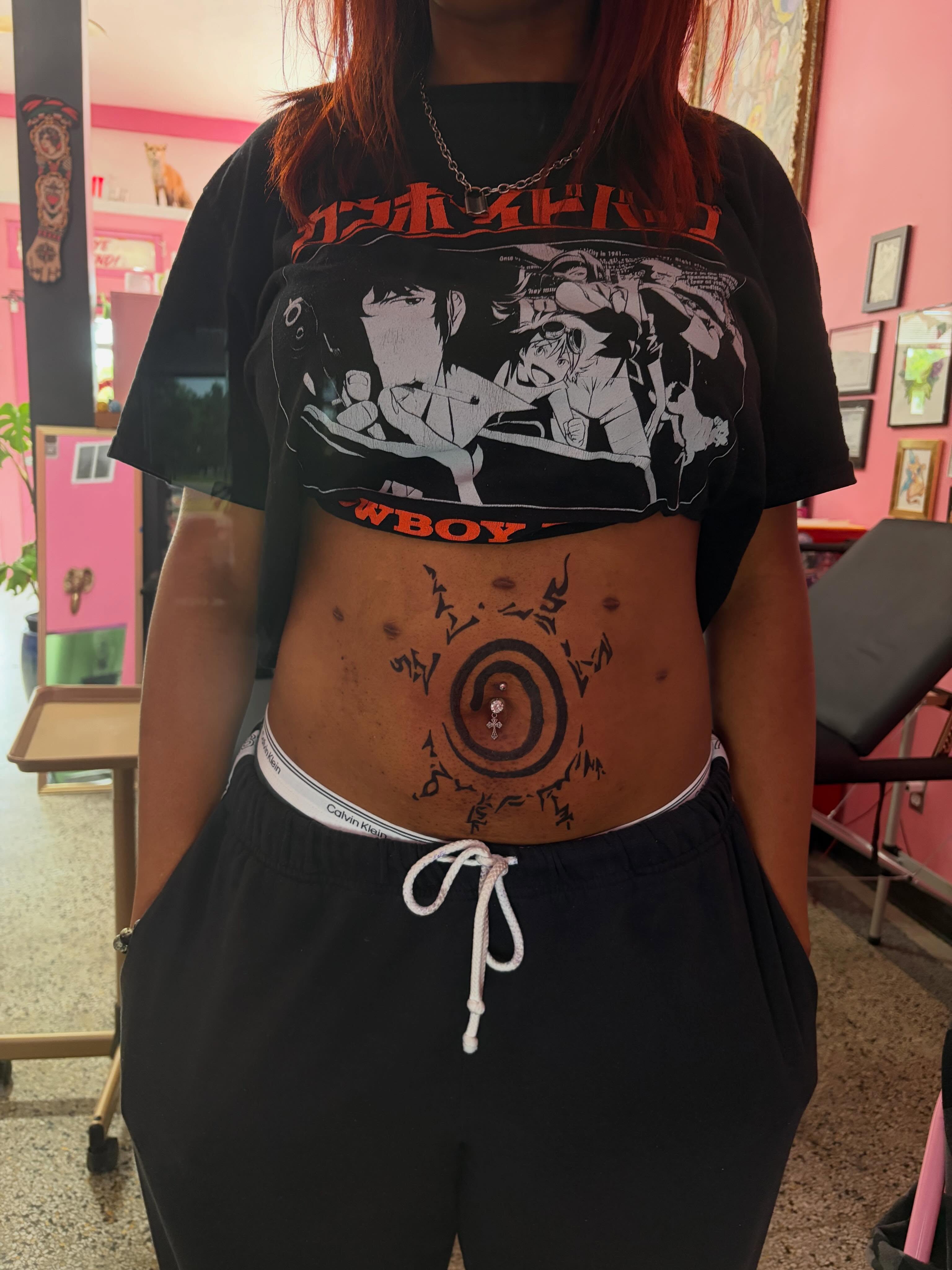 Circle with symbols dotwork tattoo on the torso by neal