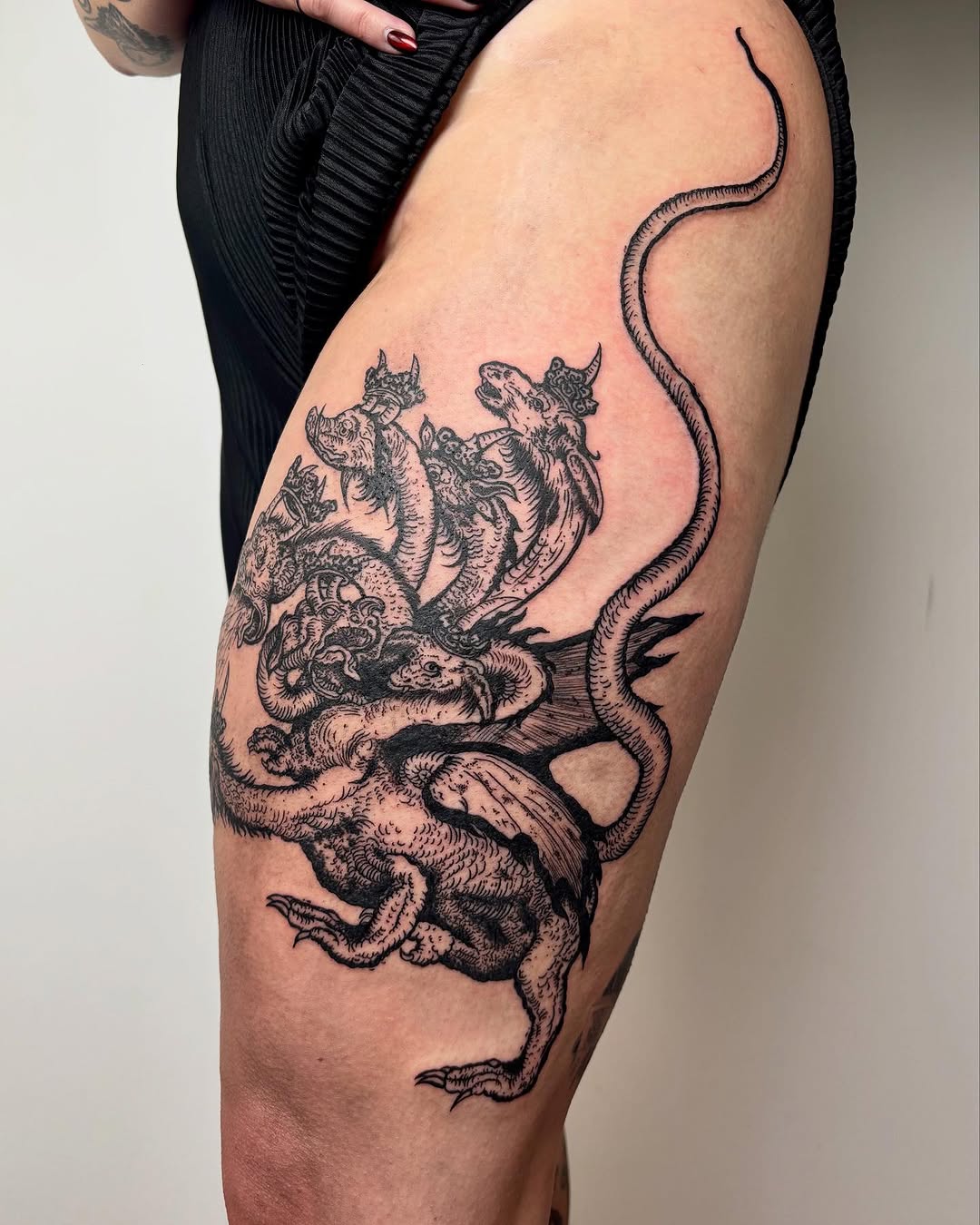 Multi-headed dragon creature cyber sigilism tattoo on the thigh by kendle