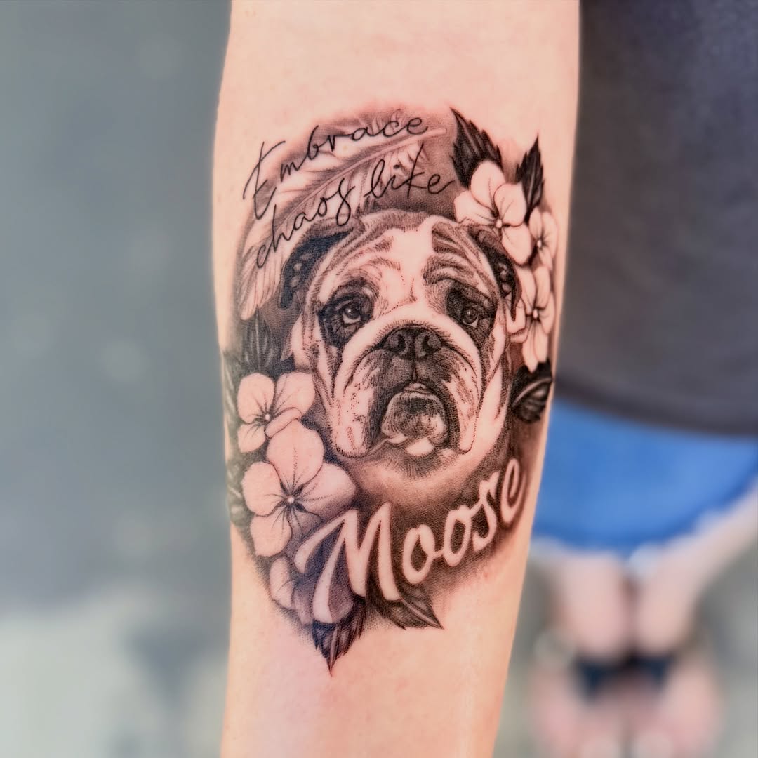 Bulldog portrait with flowers and text realism tattoo on the forearm by Maggie George