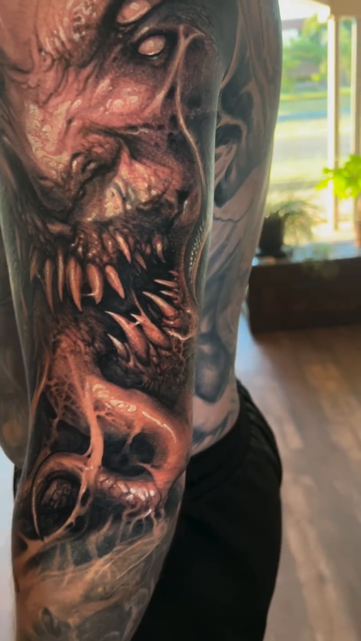Demonic creature sleeve realism tattoo on the upper arm by David Jorquera