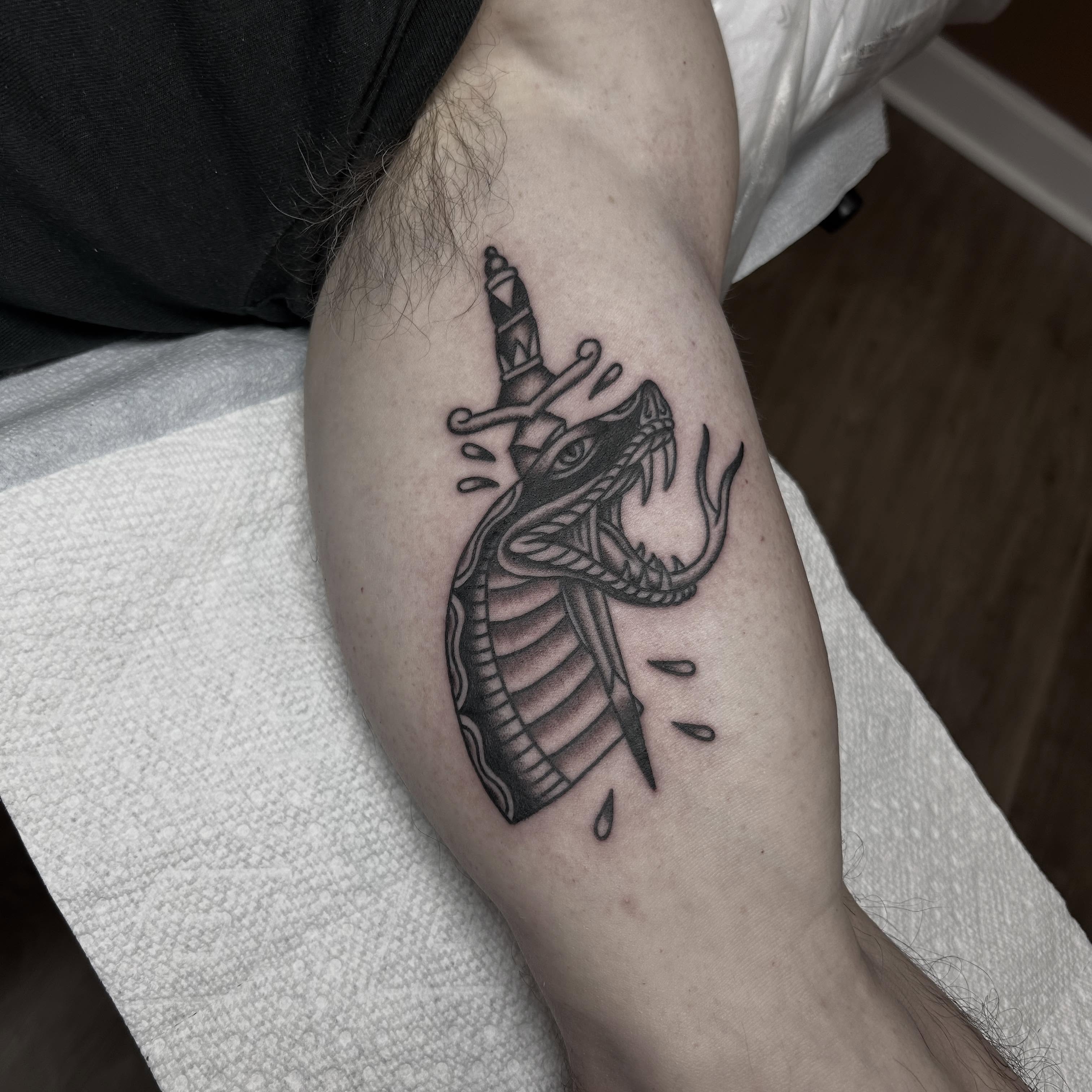 Cobra black and grey tattoo on the forearm by Stephen Sanchez