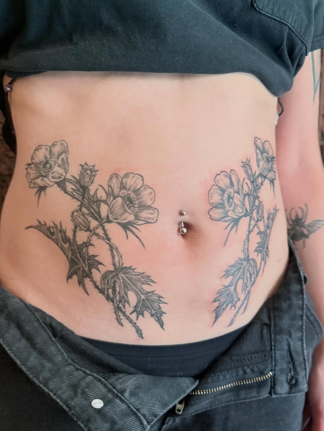 Flowers and leaves fine line tattoo on the torso by Emily Rose Lumsdaine