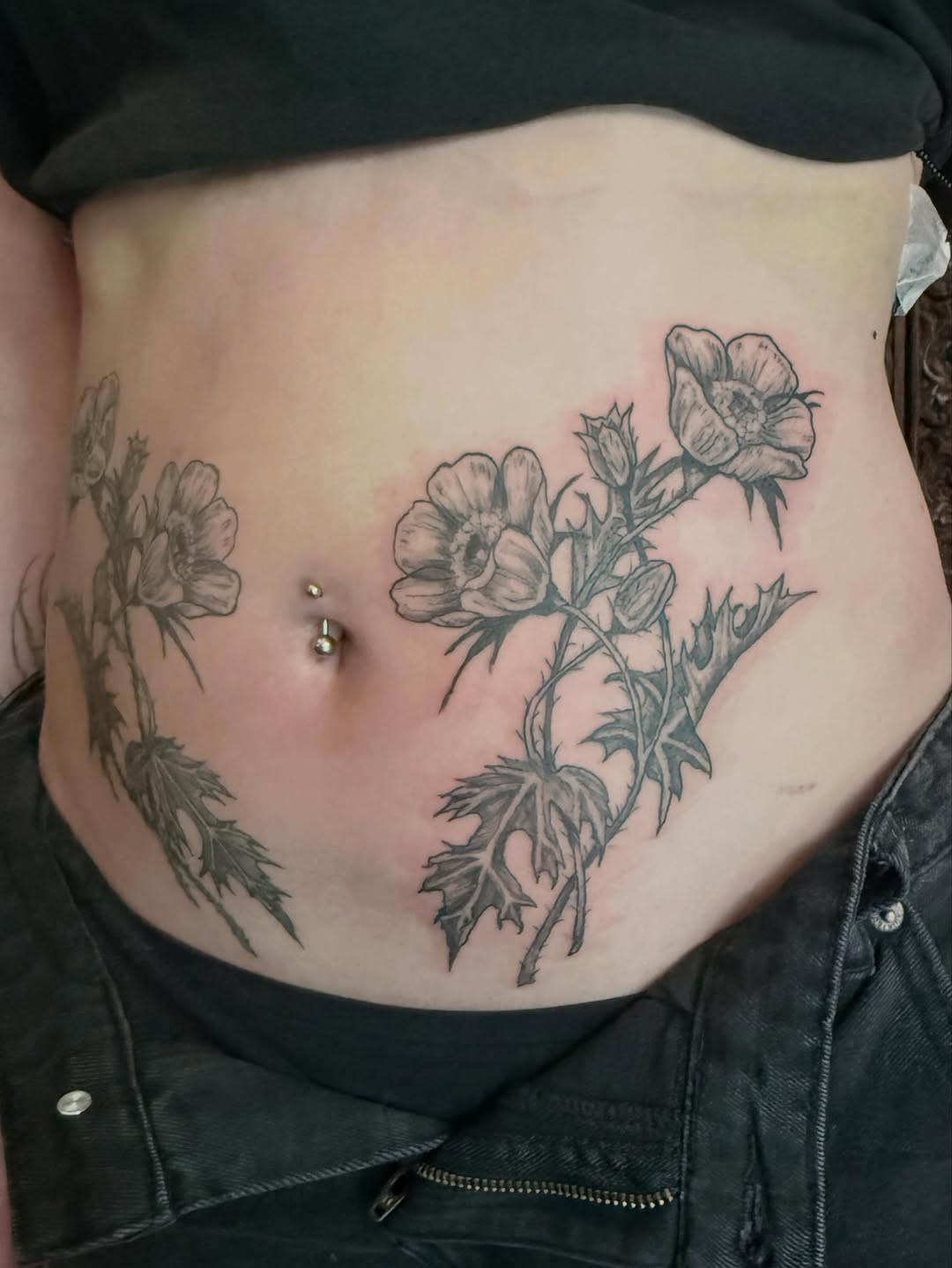 Floral tattoo on stomach fine line tattoo on the torso by Emily Rose Lumsdaine