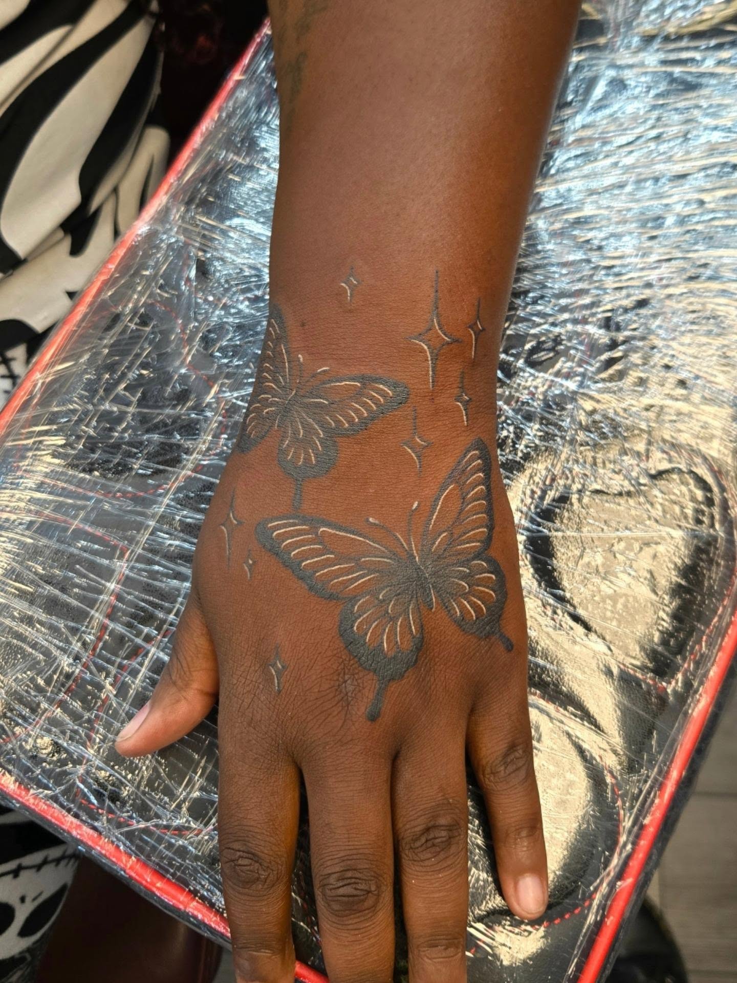 Butterflies black and grey tattoo on the hand by Danielle Elizabeth