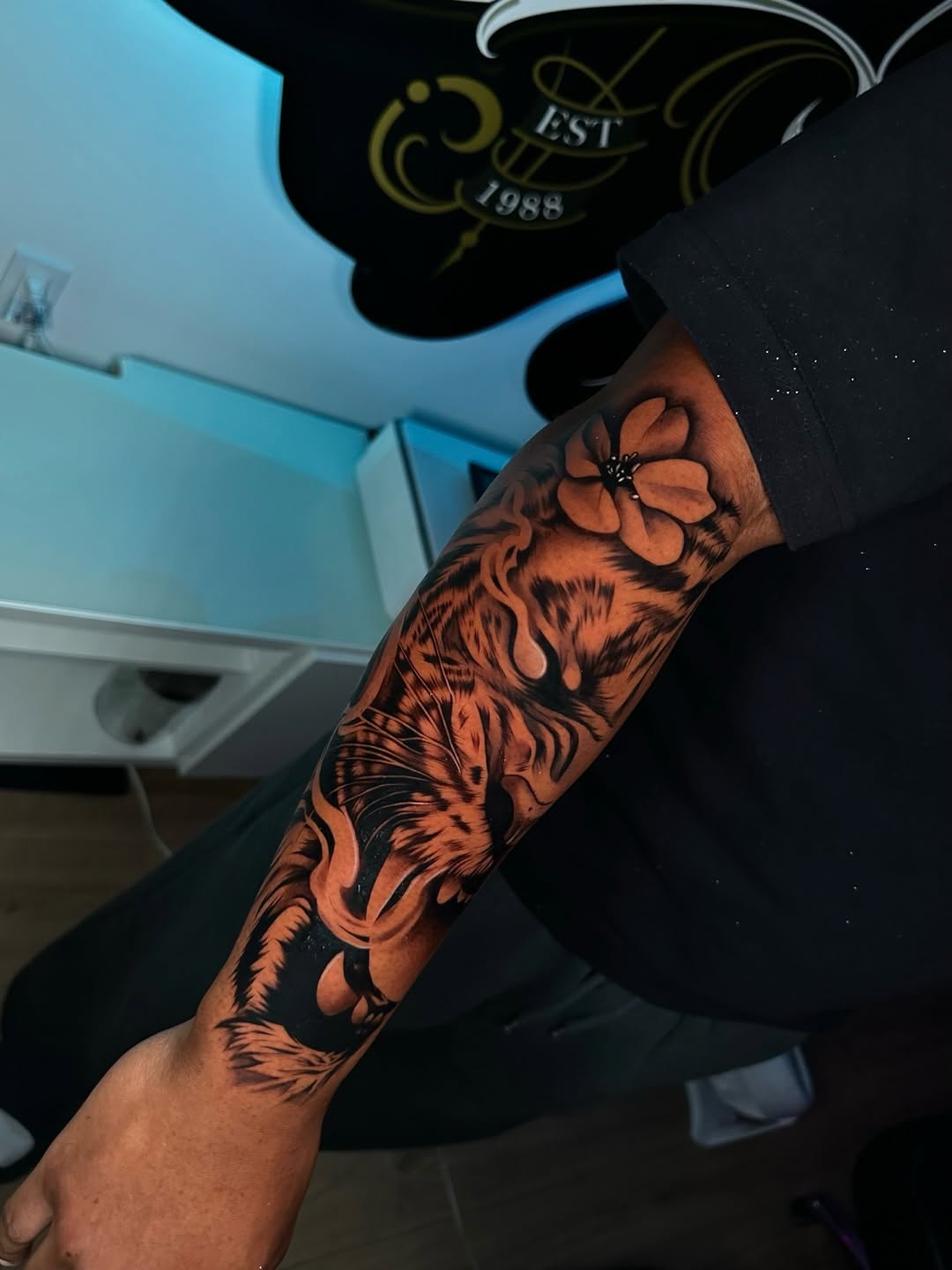 Tiger and flower realism tattoo on the forearm by Emma Sferdian🇷🇴