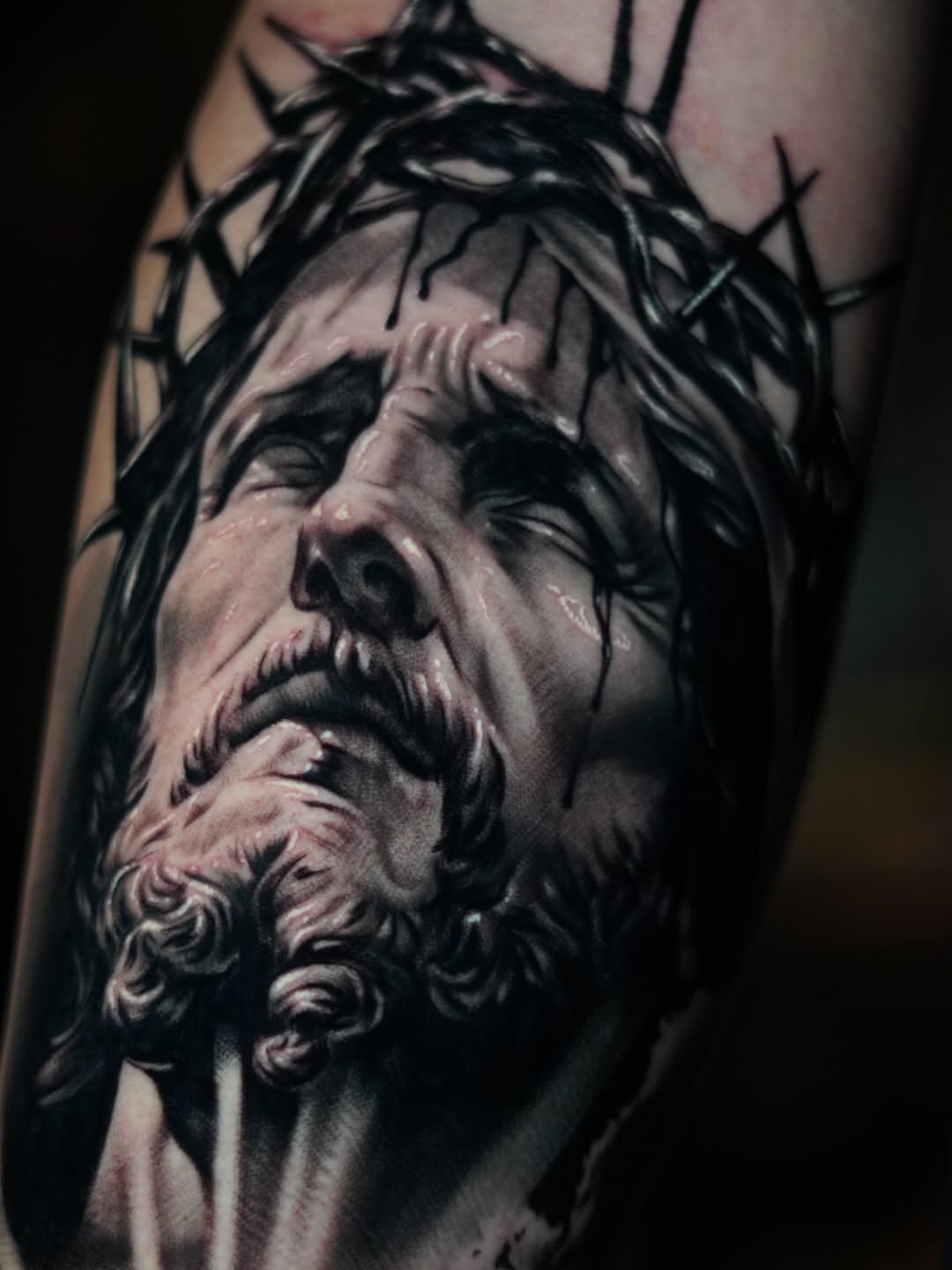 Jesus Christ portrait realism tattoo on the forearm by Bailey Hancock