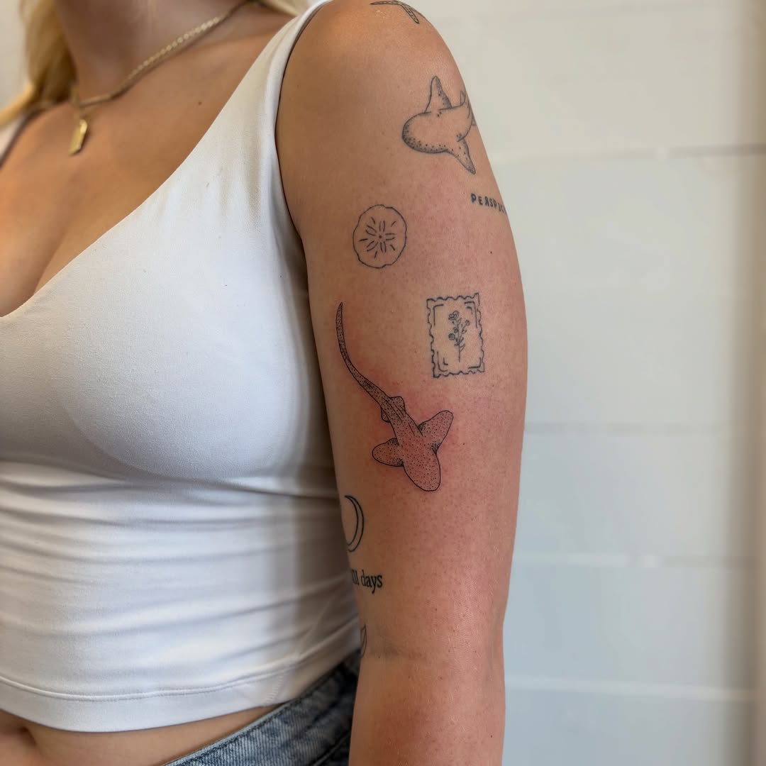 Shark minimalist tattoo on the forearm by Sweet Ink Tattoo