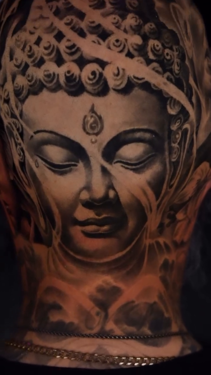 Buddha and faces realism tattoo by Anthony Maya