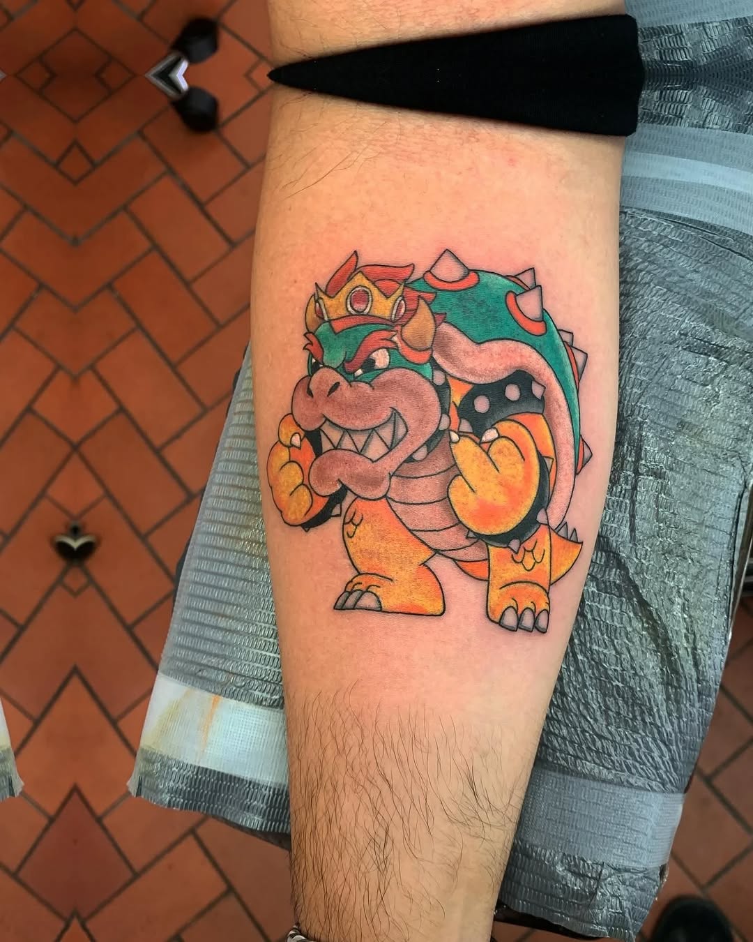 Bowser from Super Mario new school tattoo on the forearm by Murl Dietrich
