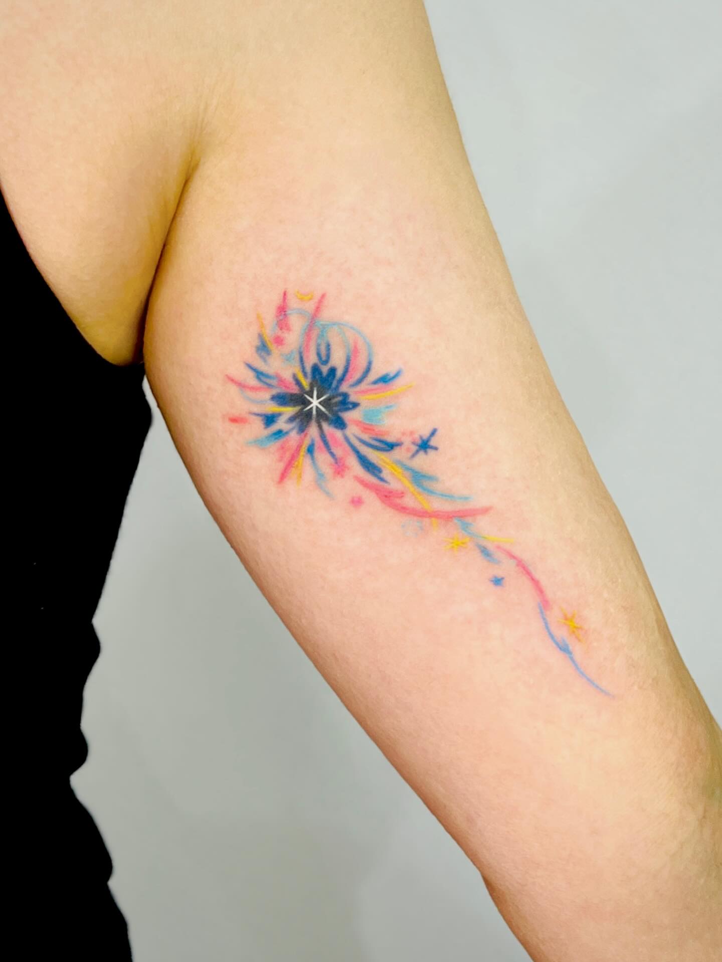 Watercolor burst watercolor tattoo on the forearm by Purinn