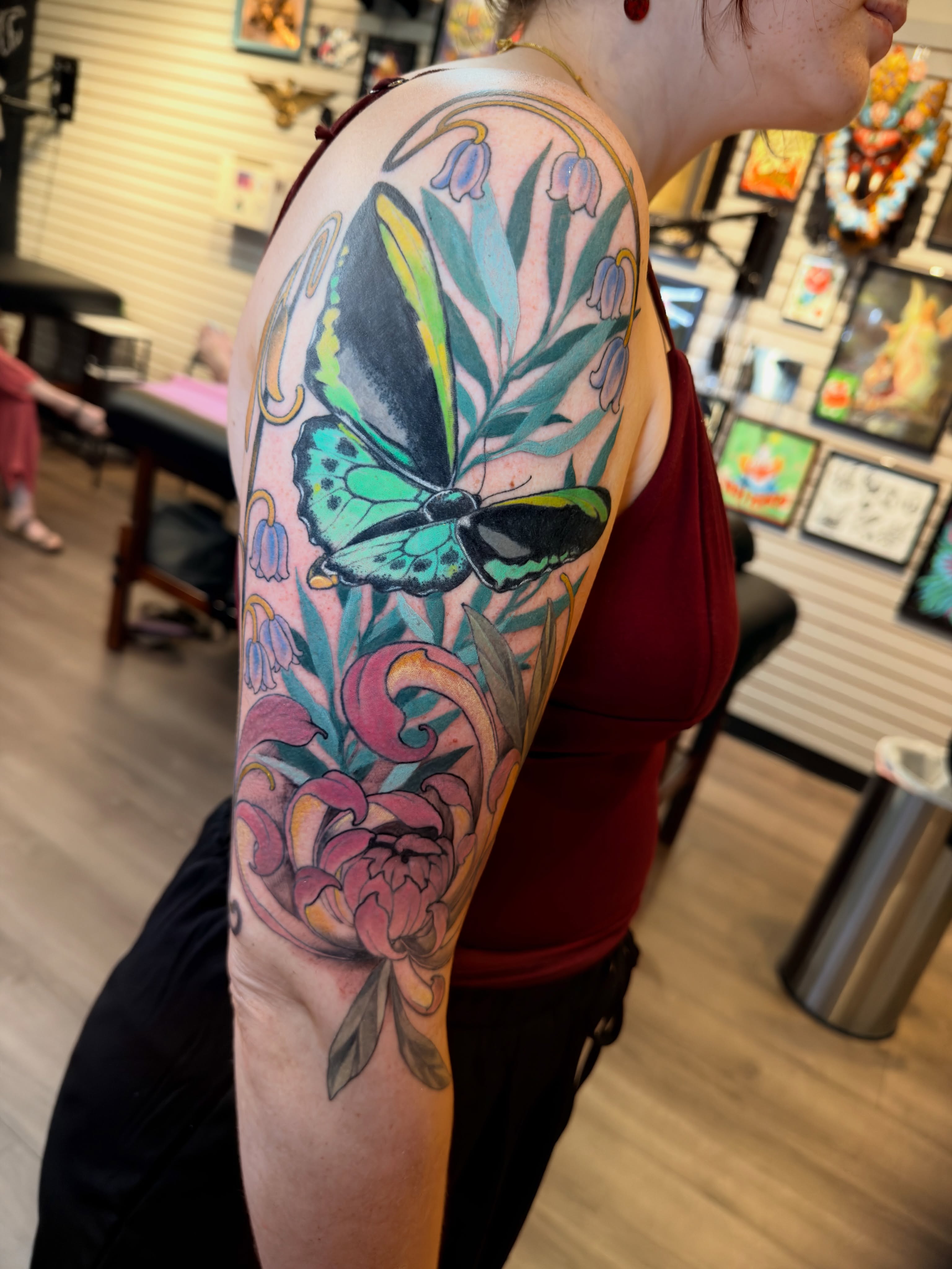 Butterfly and floral new school tattoo on the forearm by Jenn Golgan