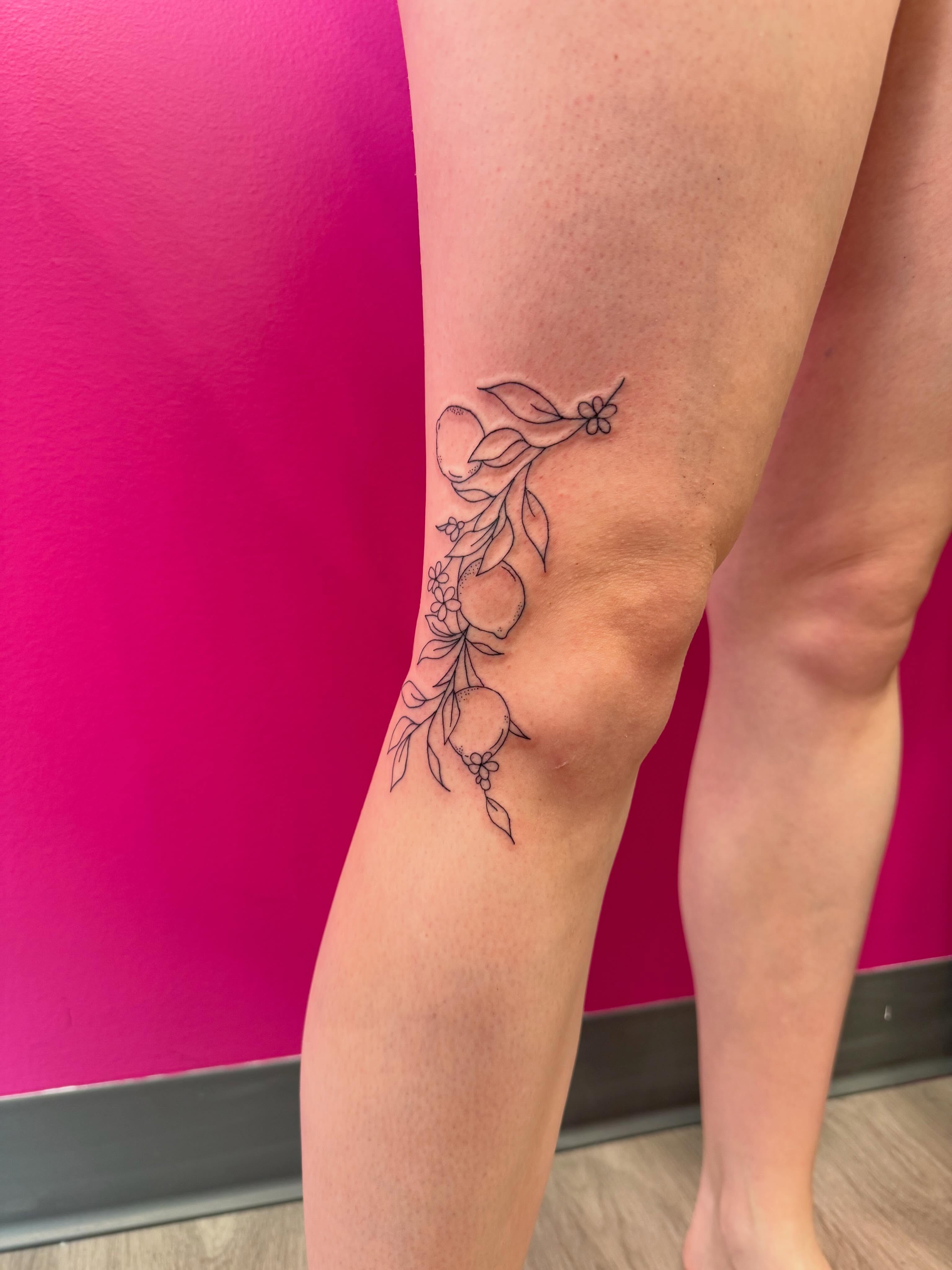 Fruit and leaves fine line tattoo on the leg by fine line tattoos