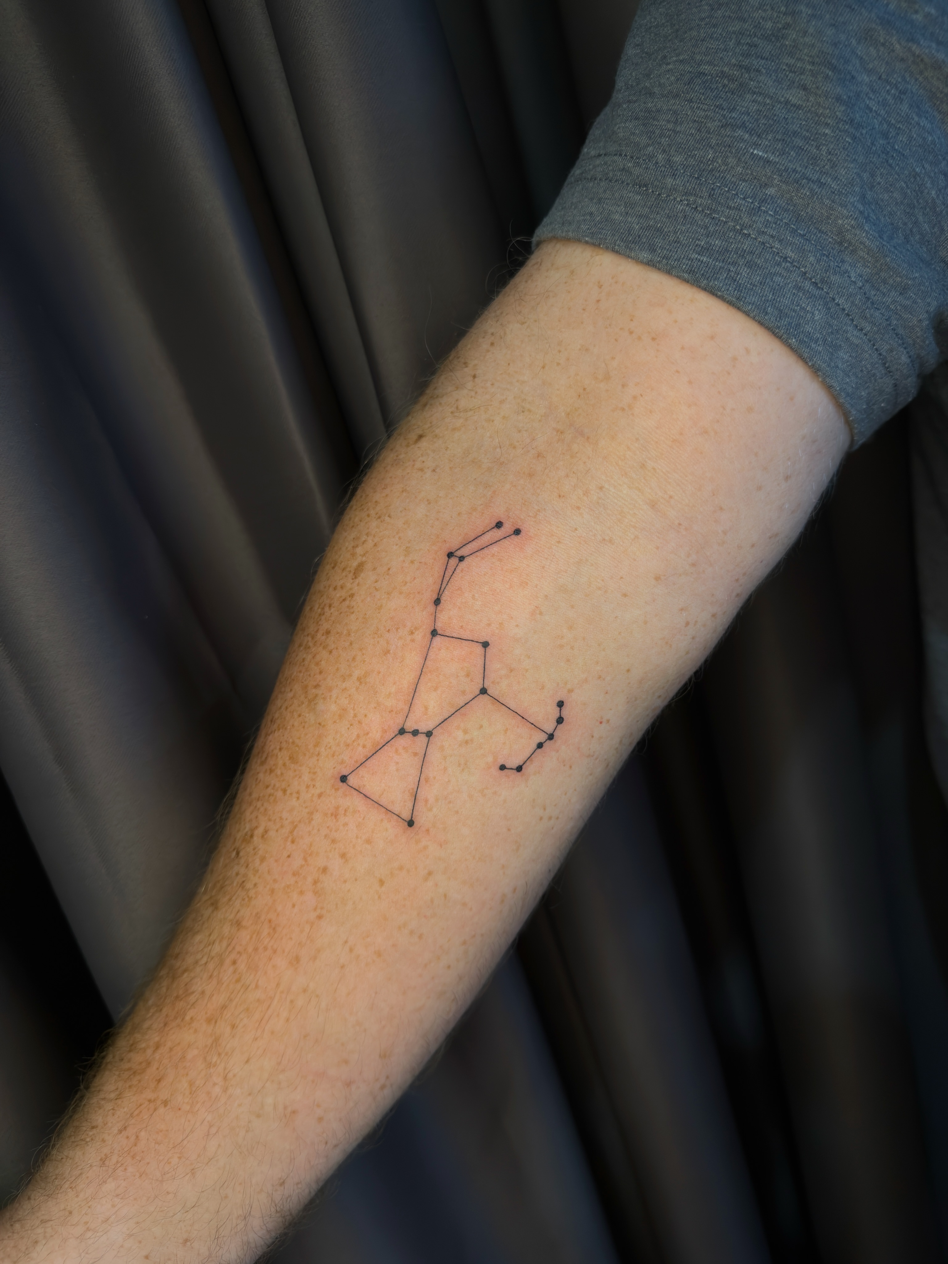 Constellation geometric tattoo on the forearm by Hector Torres