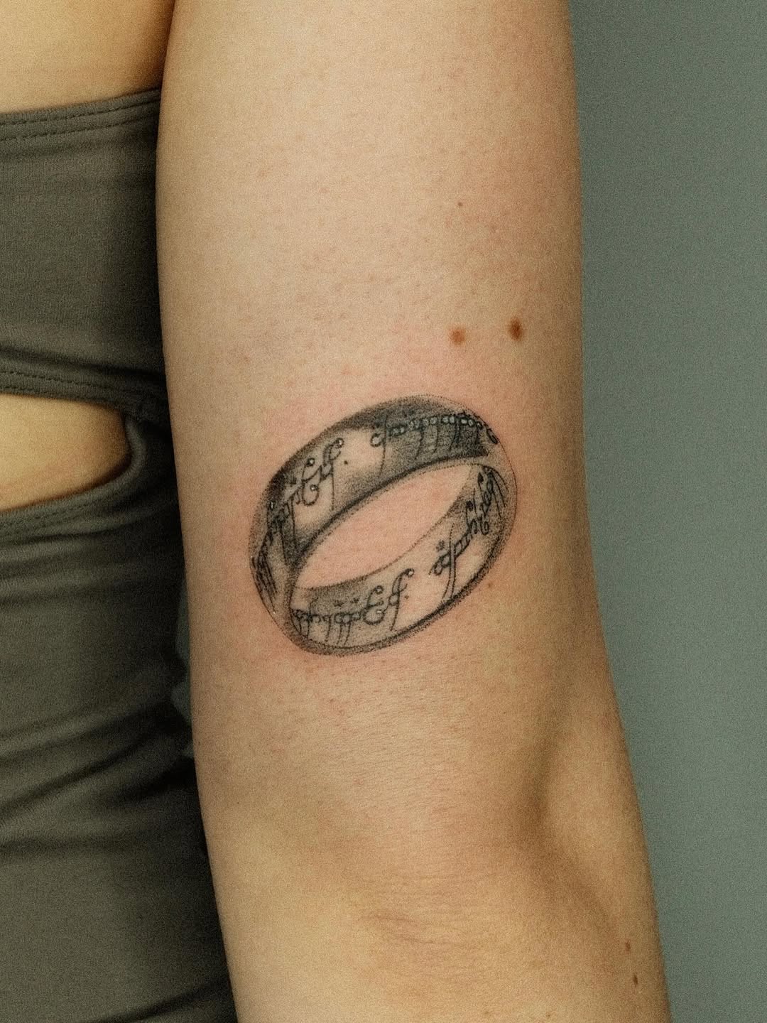 The One Ring inscription surrealism tattoo on the forearm by Thiên Hồ