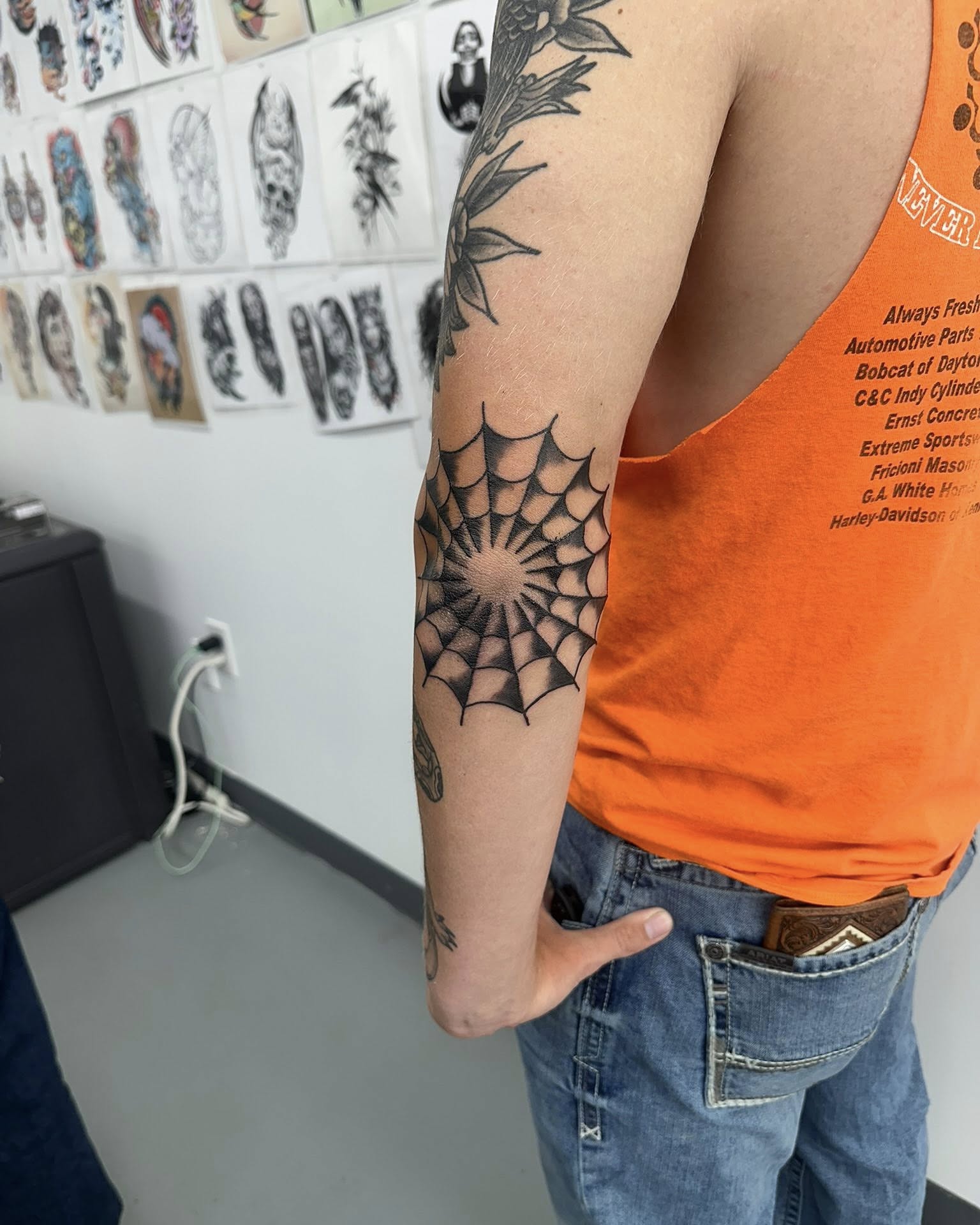 Spiderweb geometric tattoo on the forearm by Brian Lambert