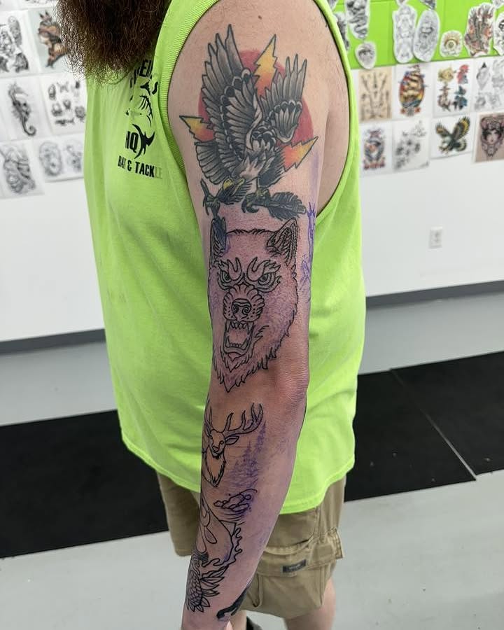 Wolf head with eagle American traditional tattoo on the forearm by Brian Lambert