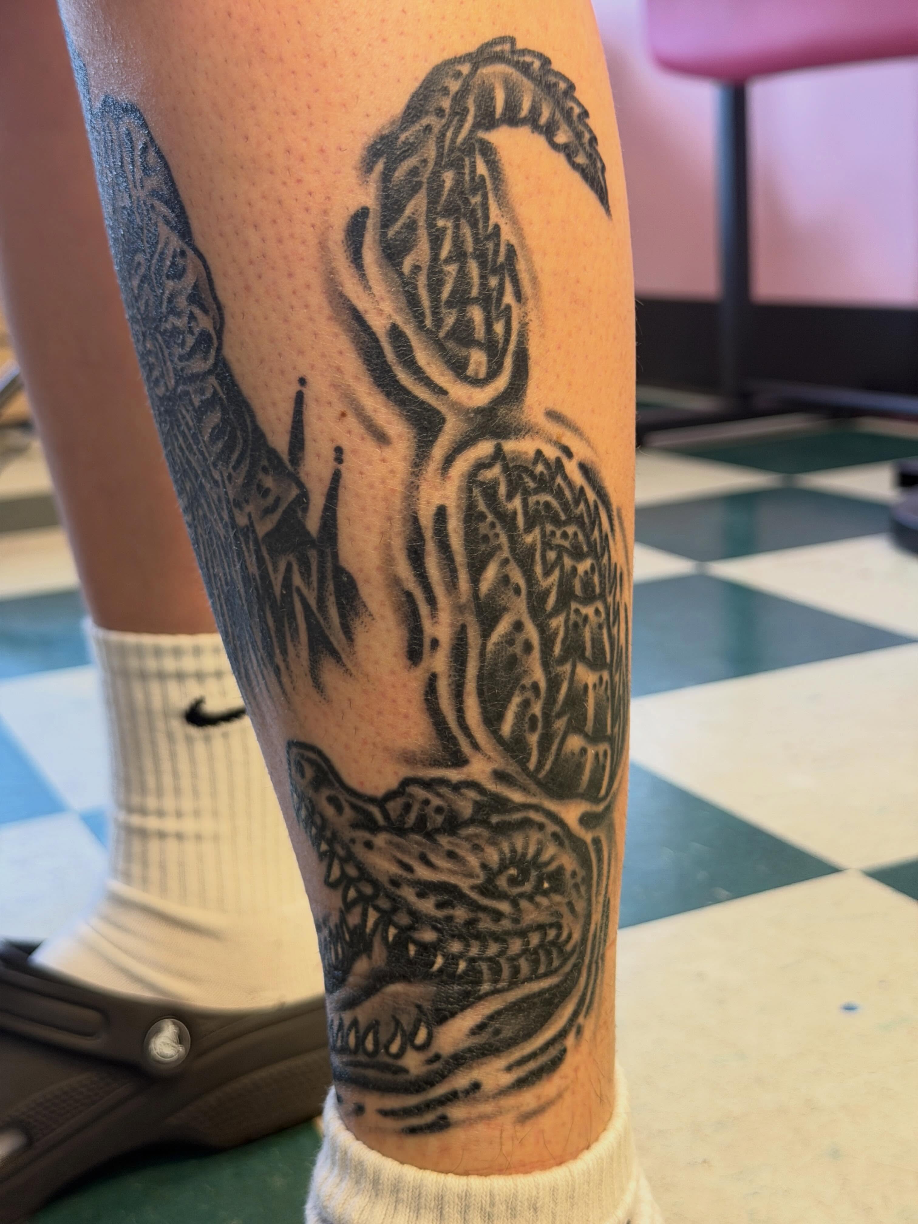Alligator black and grey tattoo on the forearm by Joshua Speight