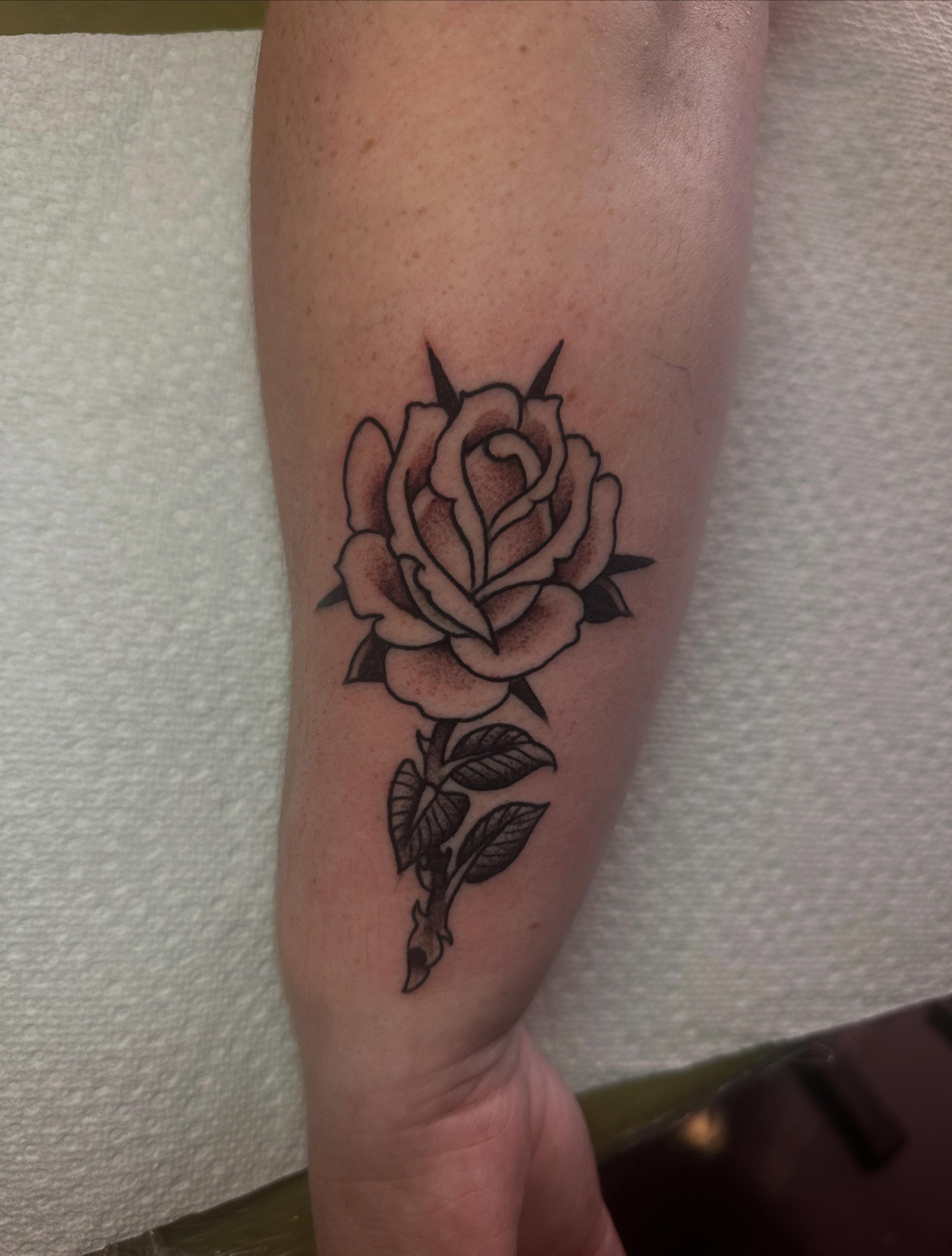 Rose black and grey tattoo on the forearm by Chris Bishop