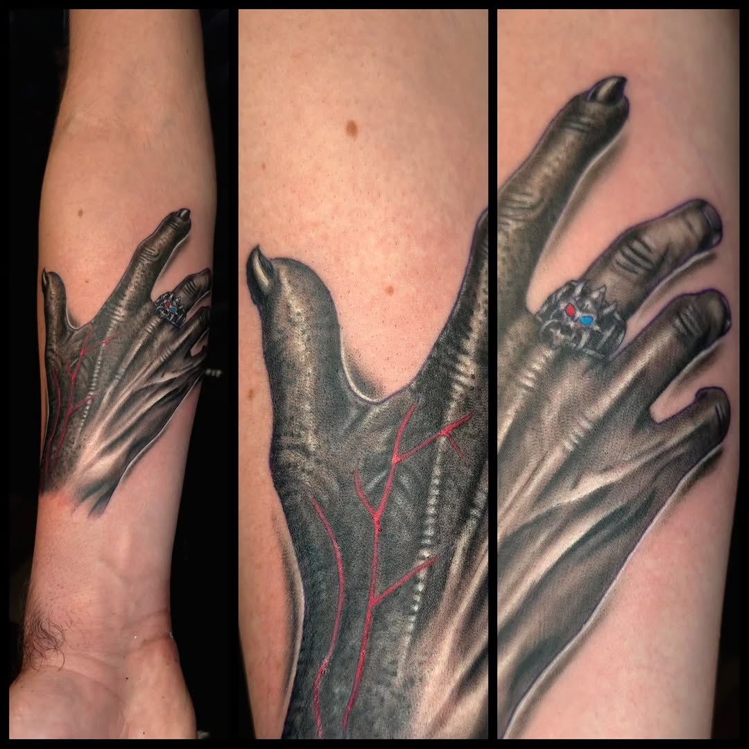 Creepy hand with ring realism tattoo on the forearm by Ian Duncanson